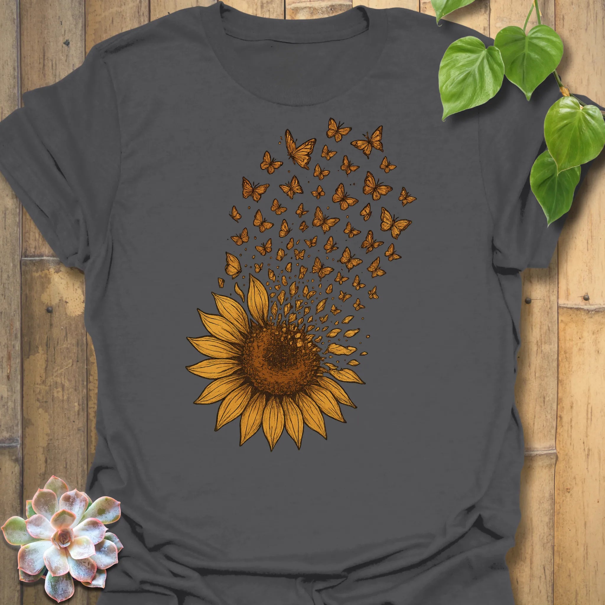 Add effortless depth with our Charcoal Sunflower Butterfly tee — a warm contrast highlighting the golden blooms and fluttering details.