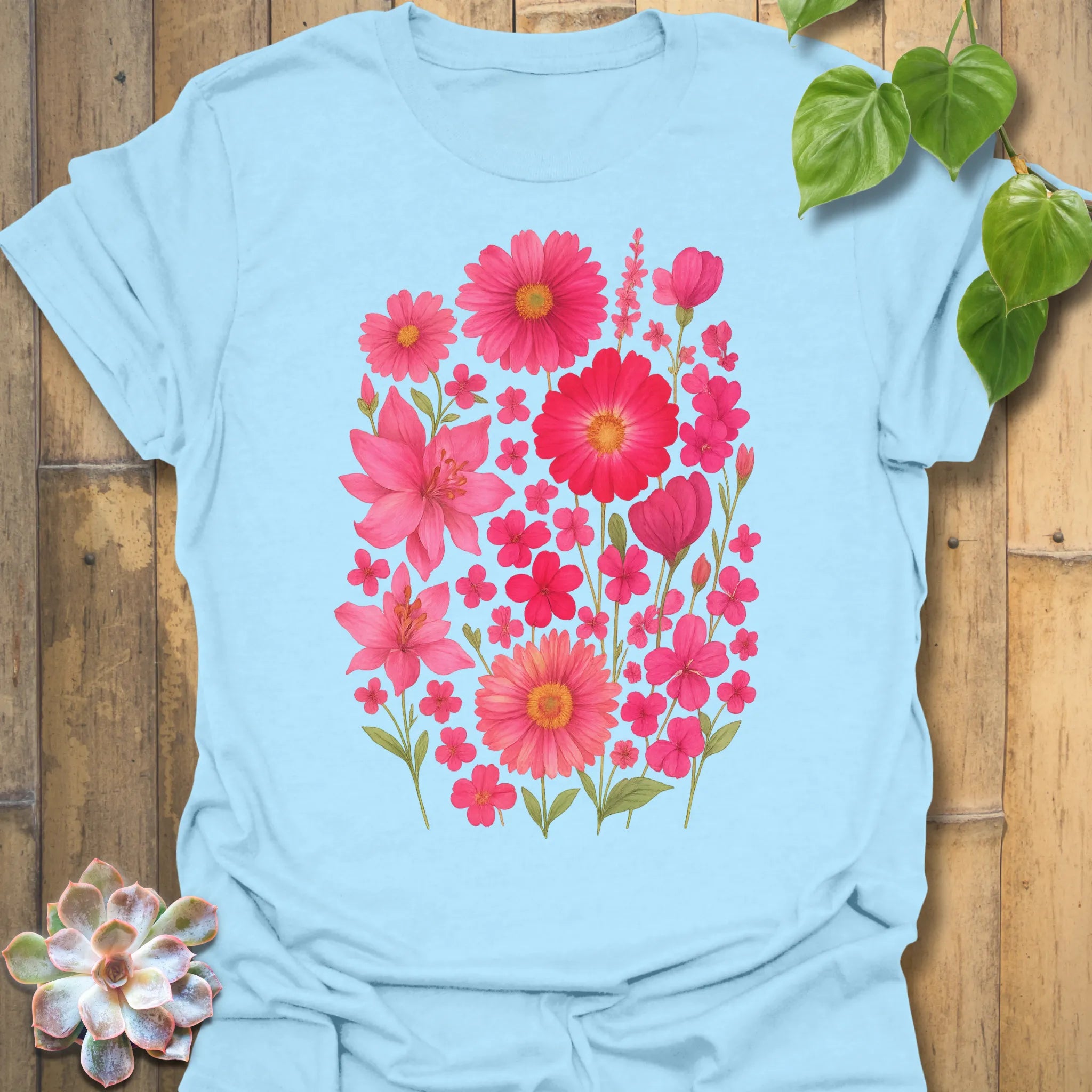Light blue “Pink Blossom” tee showcasing bright pink flower design — lightweight, breathable Gildan 64000 cotton.