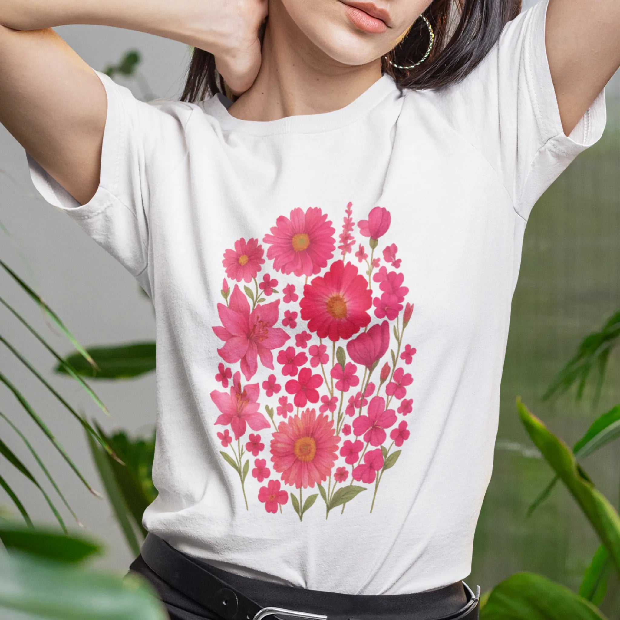 Woman wearing a white “Pink Blossom” T-shirt with vivid pink flower design — cheerful, relaxed fit ideal for everyday wear.