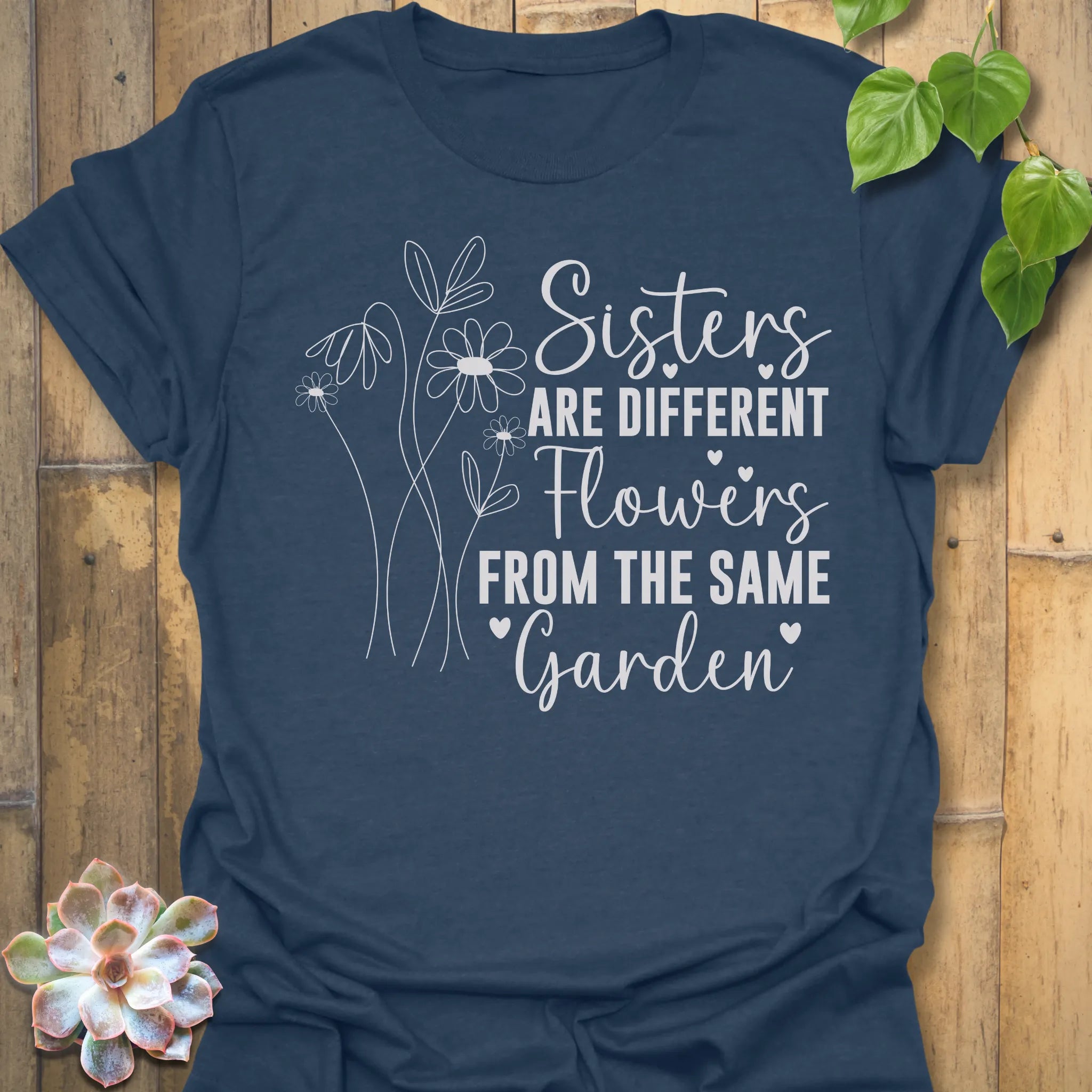 Heather Nave t-shirt with floral design with saying Sisters are different flowers from the same garden
