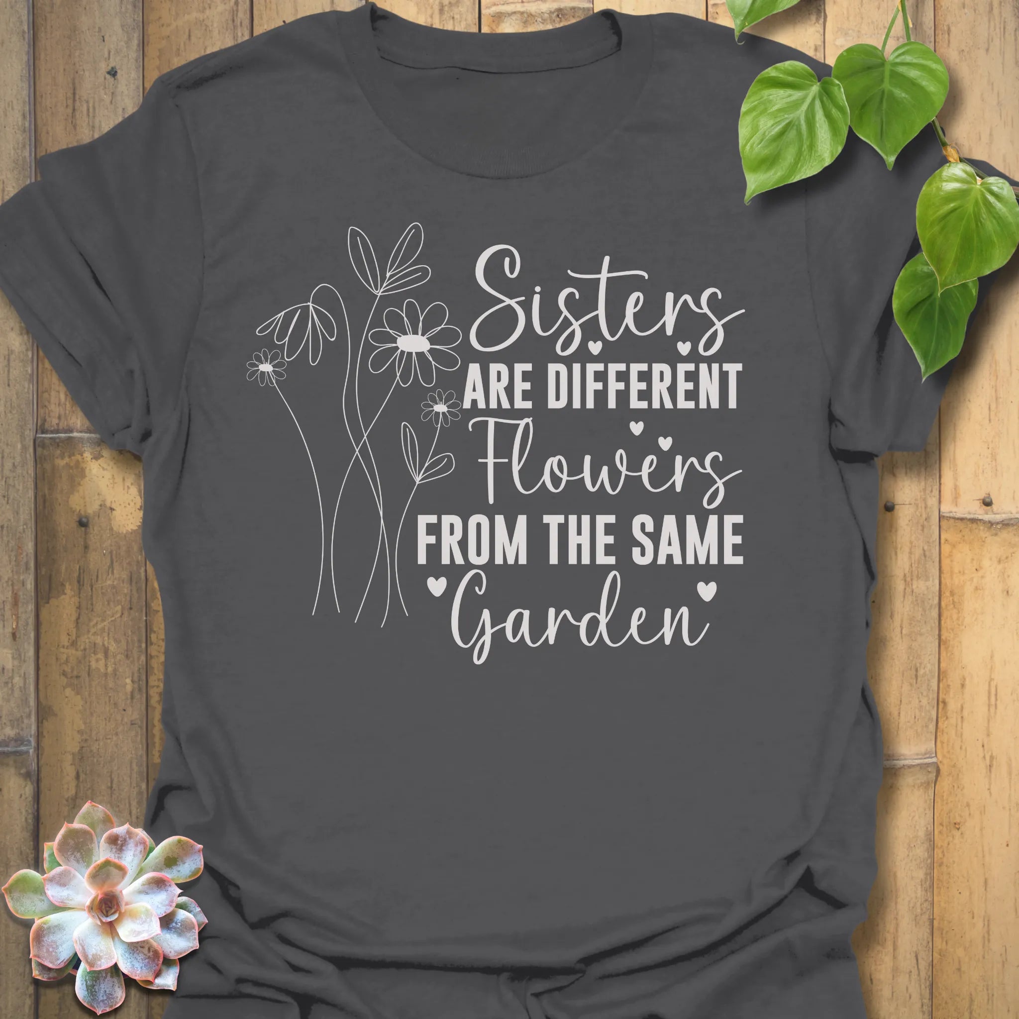 Dark Heather grey t-shirt with floral design with saying Sisters are different flowers from the same garden