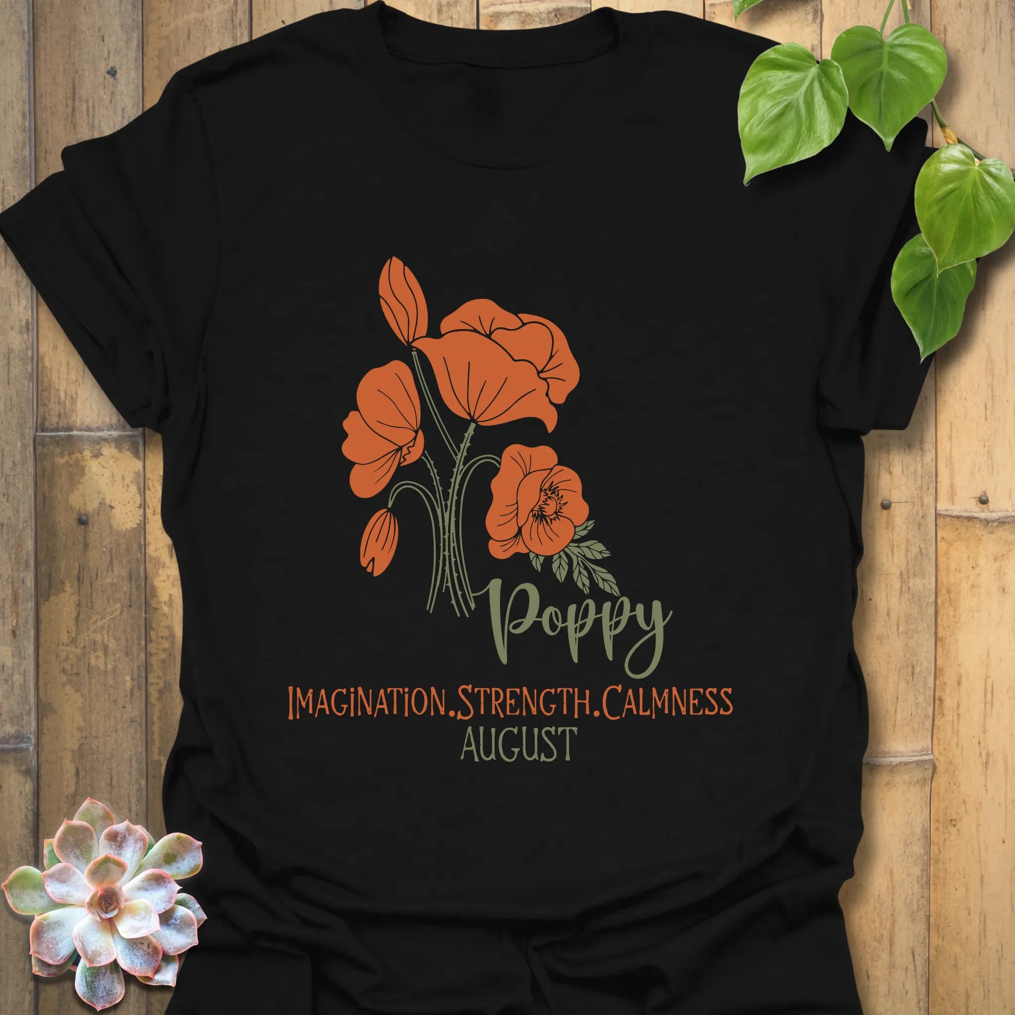 Black t-shirt featuring the design August Poppy with a floral print, a bold flower graphic tee for a stylish and timeless look.