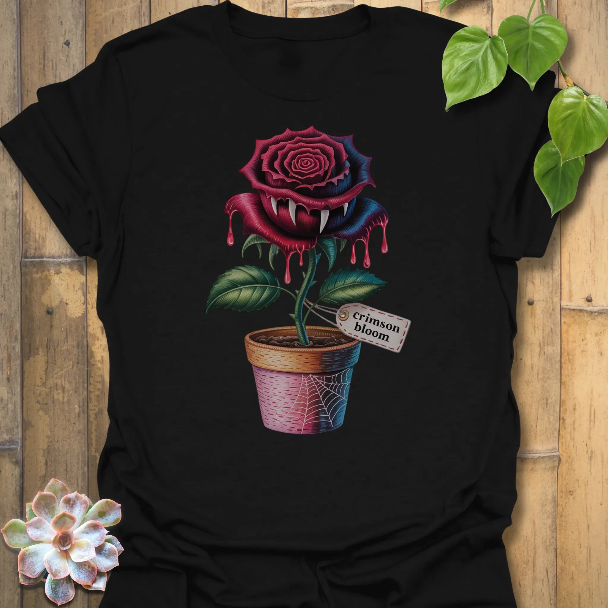 Black t-shirt featuring the design Crimson Bloom printed in halloween floral graphic tee.