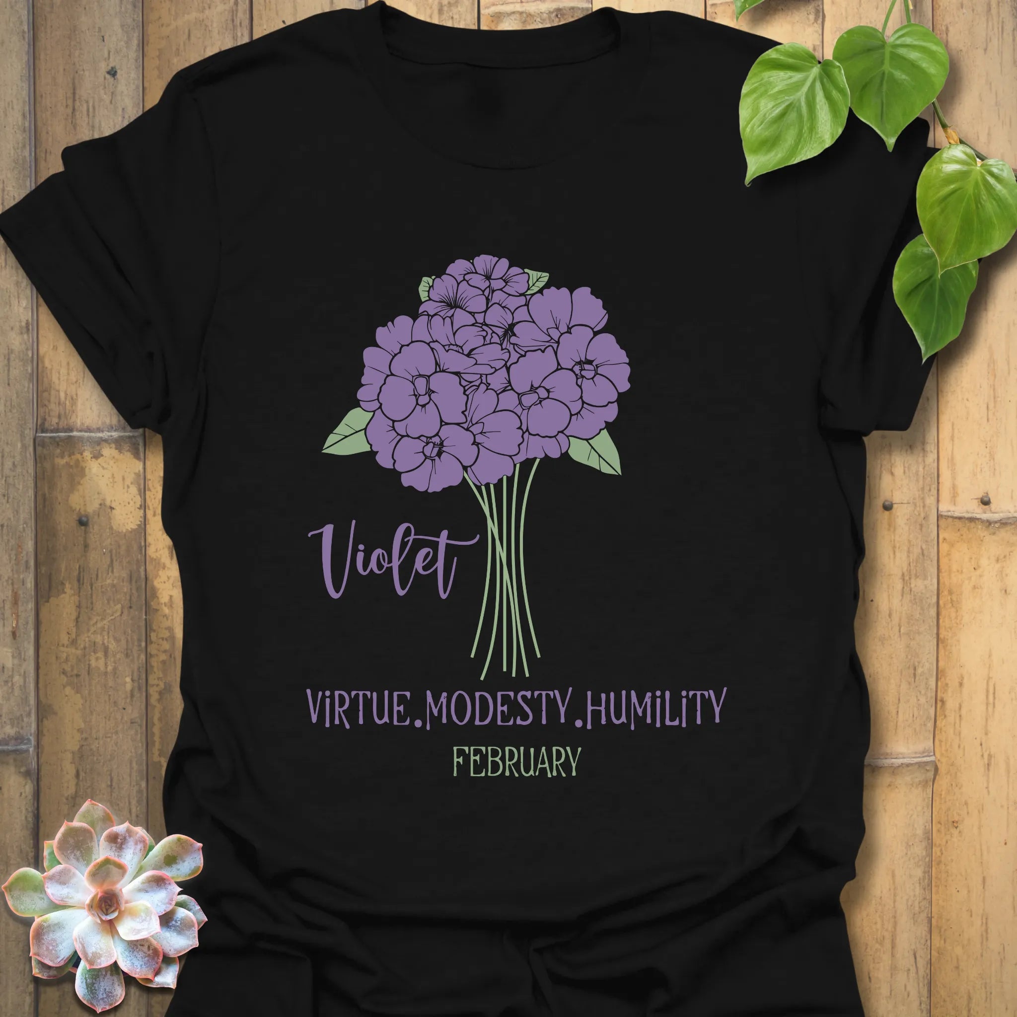 Black t-shirt featuring the design February Violet with a rose flower print, a bold floral print shirt great for gifting.