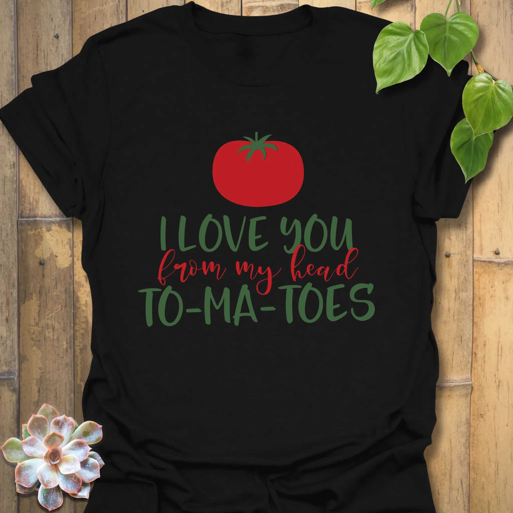 Black t-shirt featuring the design I Love You From My Head TO-MA-TOES in bold tomato print, trendy funny pun shirt.