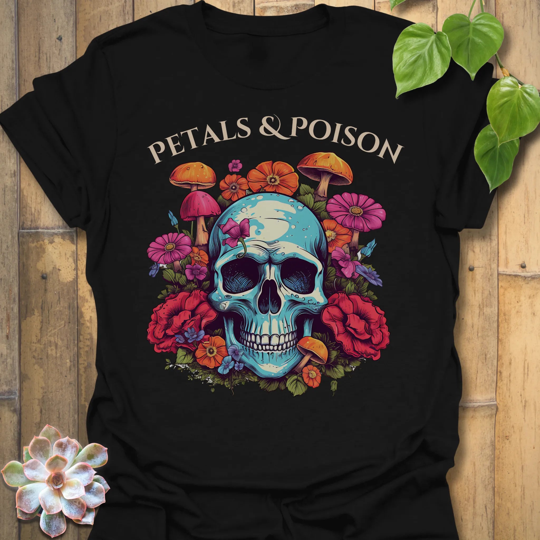 Black t-shirt featuring the design Petals & Poison printed in bold letters, gothic floral shirt.