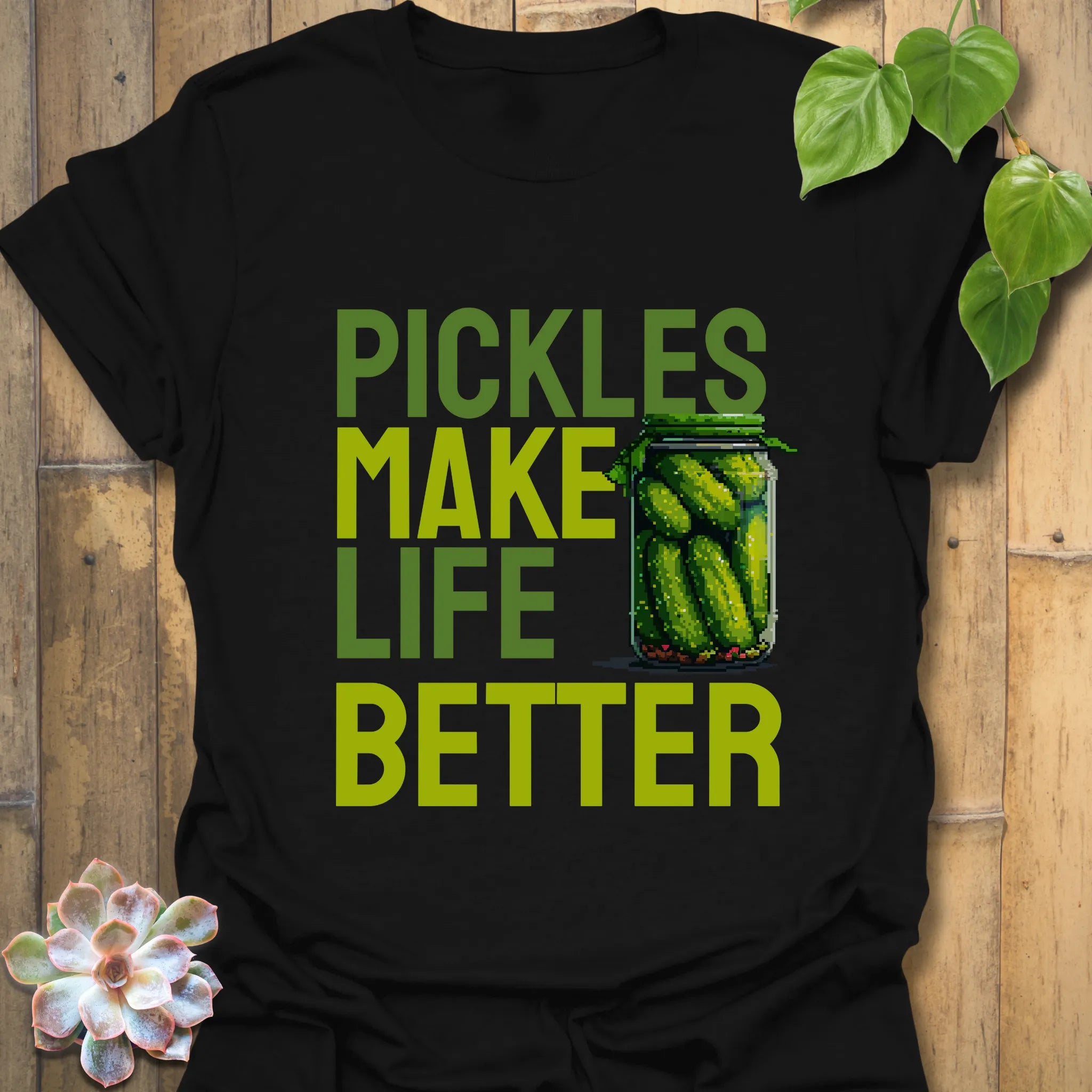 Black t-shirt featuring the design “Pickles make life better” with cucumbers inside a glass jar