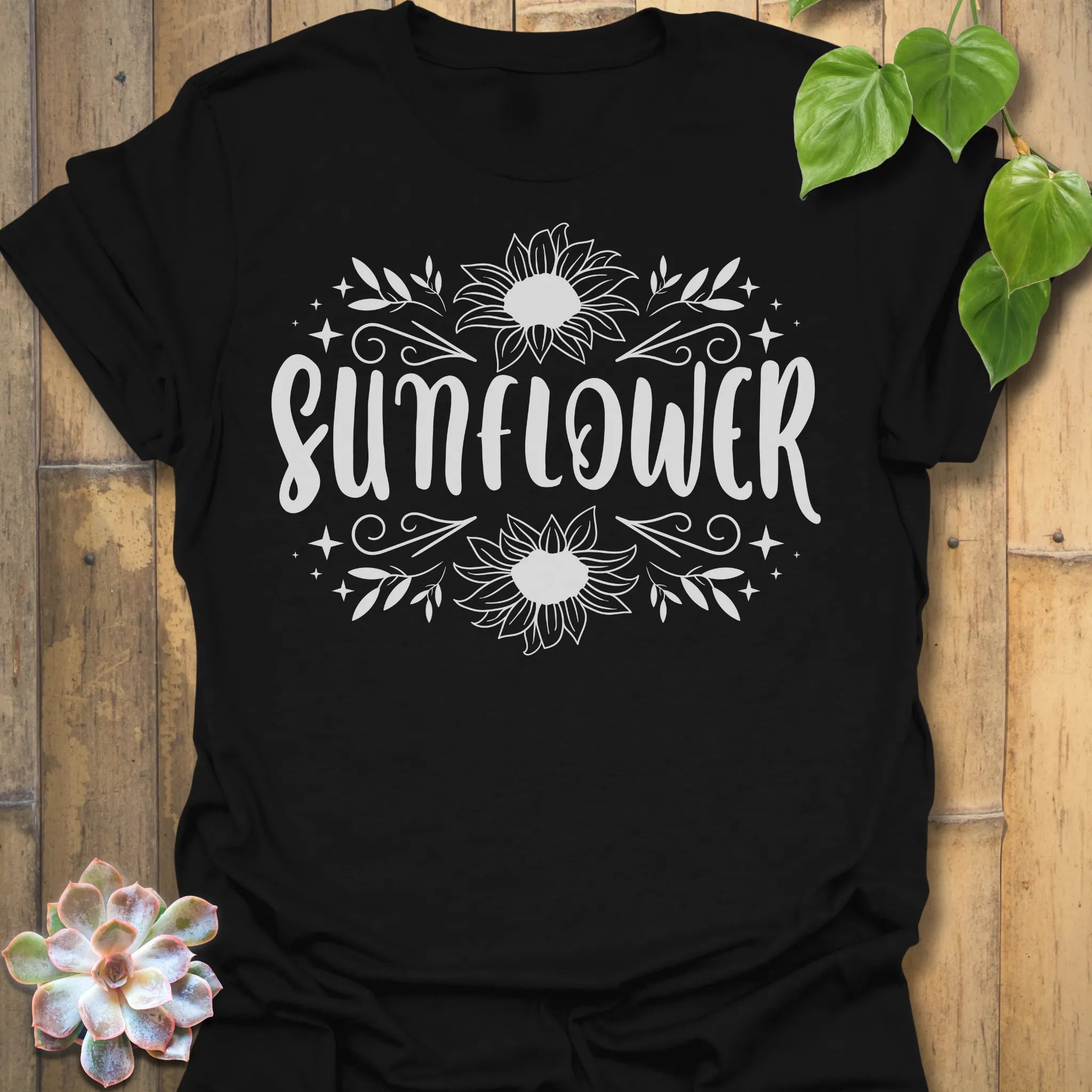 Black t-shirt featuring the design Sunflower printed inbold white, sunflower floral graphic tee.