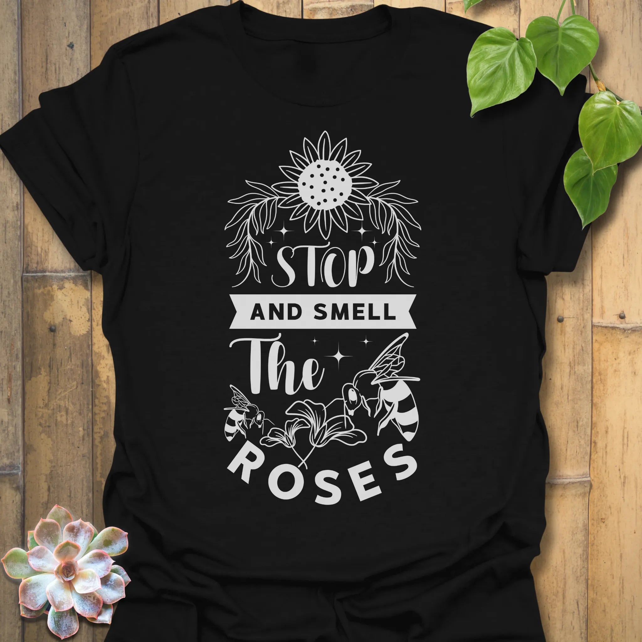 Black t-shirt featuring the design The Roses printed in artistic flower, floral graphic tee.