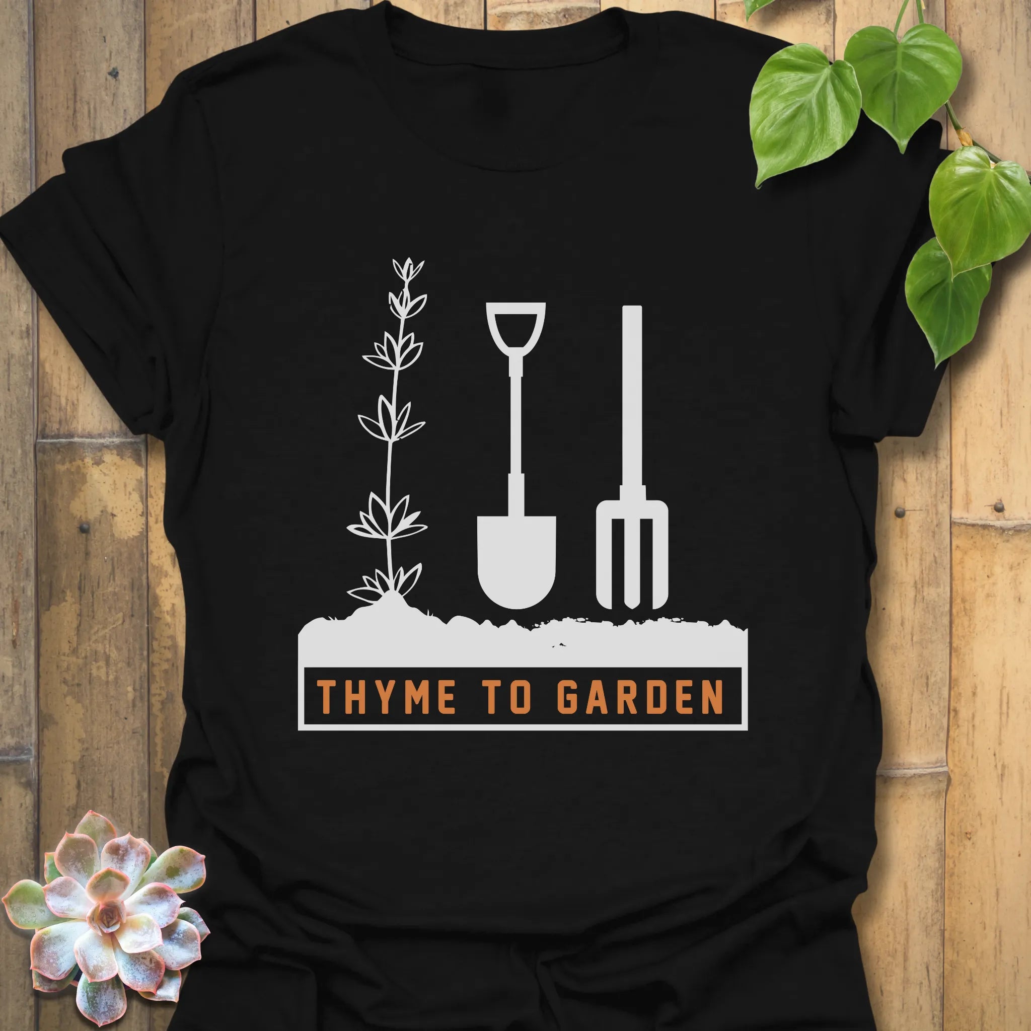 Black t-shirt featuring the design "Thyme To Garden" with gardening tool graphics, a bold garden-themed shirt for casual everyday wear.