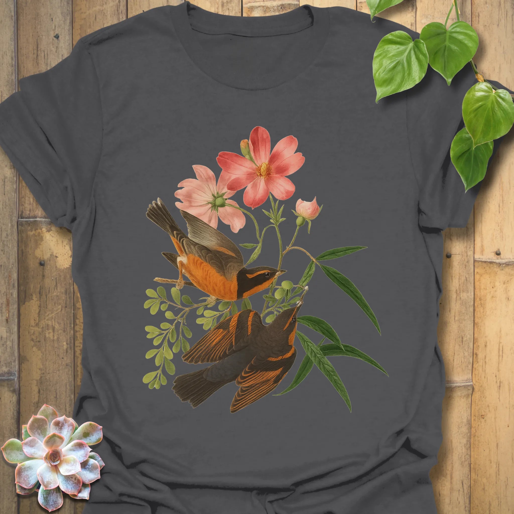 Charcoal grey t-shirt with the Spring Songbirds design showing two birds surrounded by pink blossoms and greenery