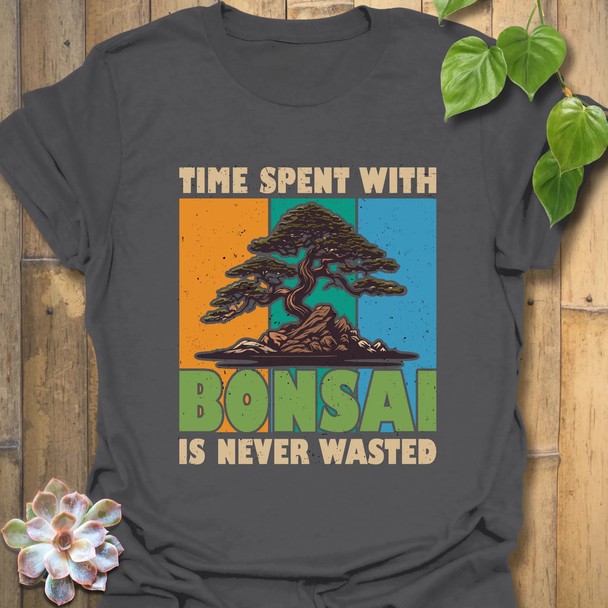 Charcoal t-shirt featuring the design “Time spent with bonsai is never wasted” with a bonsai plant print, perfect for casual outfits and bonsai enthusiasts.