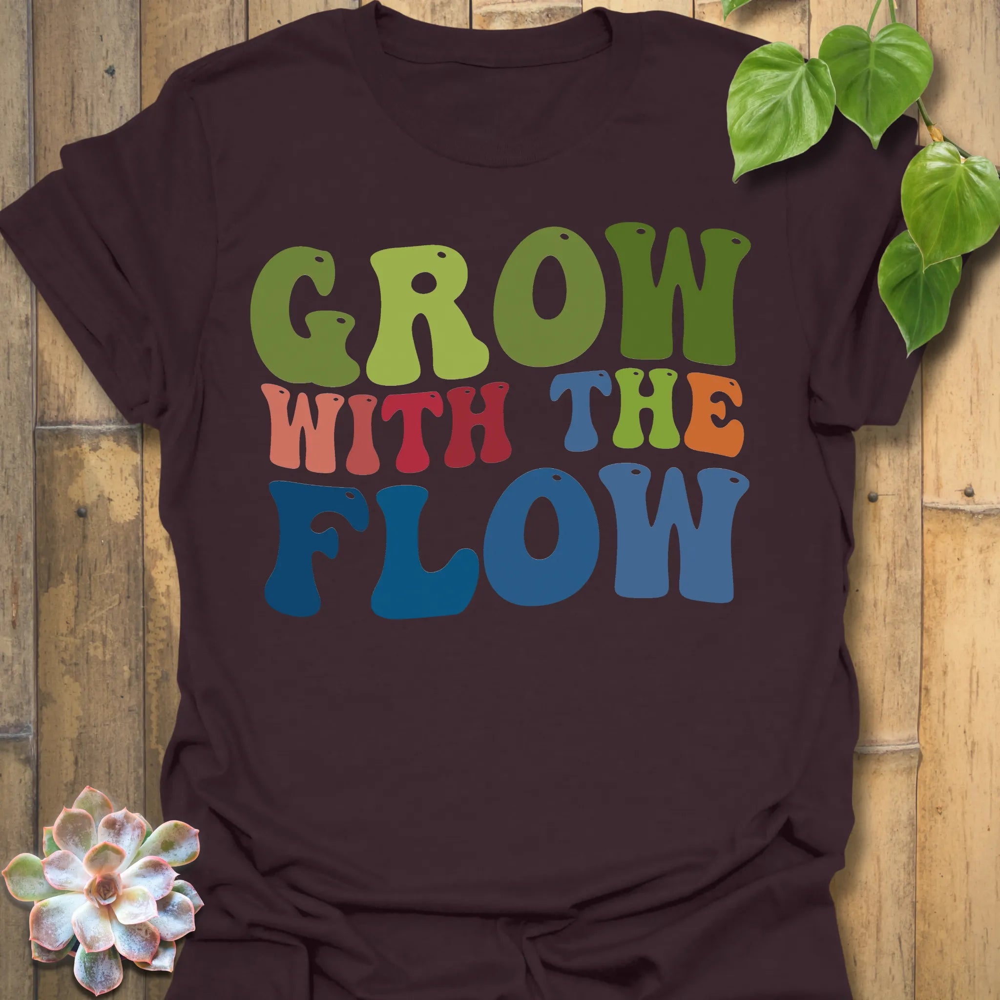 Dark Chocolate t-shirt featuring the design Grow With The Flow printed in bold colorful letters, mindful garden shirt.