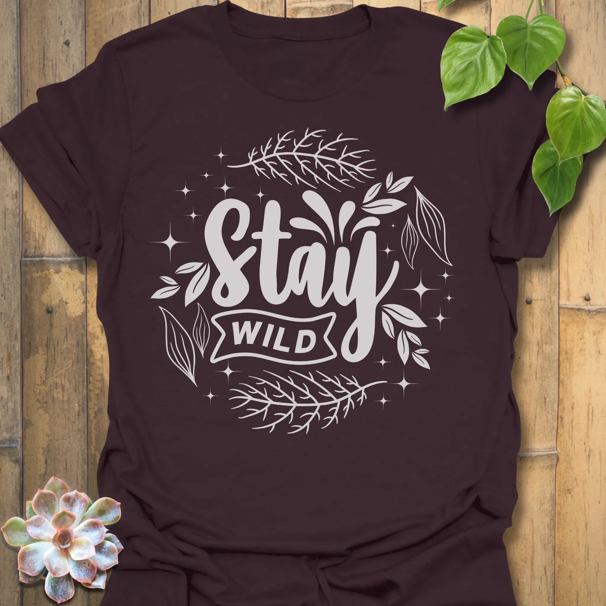 Dark Chocolate t-shirt featuring the design Stay Wild printed in bold white letters, floral graphic lover shirt.