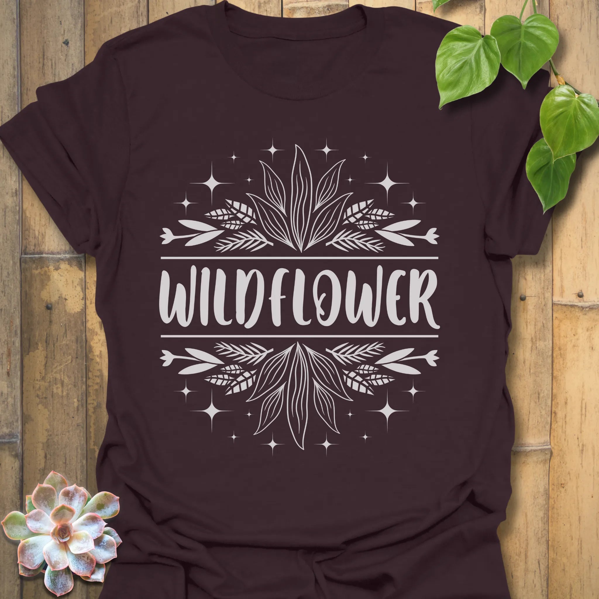 Dark Chocolate t-shirt featuring the design Wildflower printed in bold white letters, floral graphic shirt.
