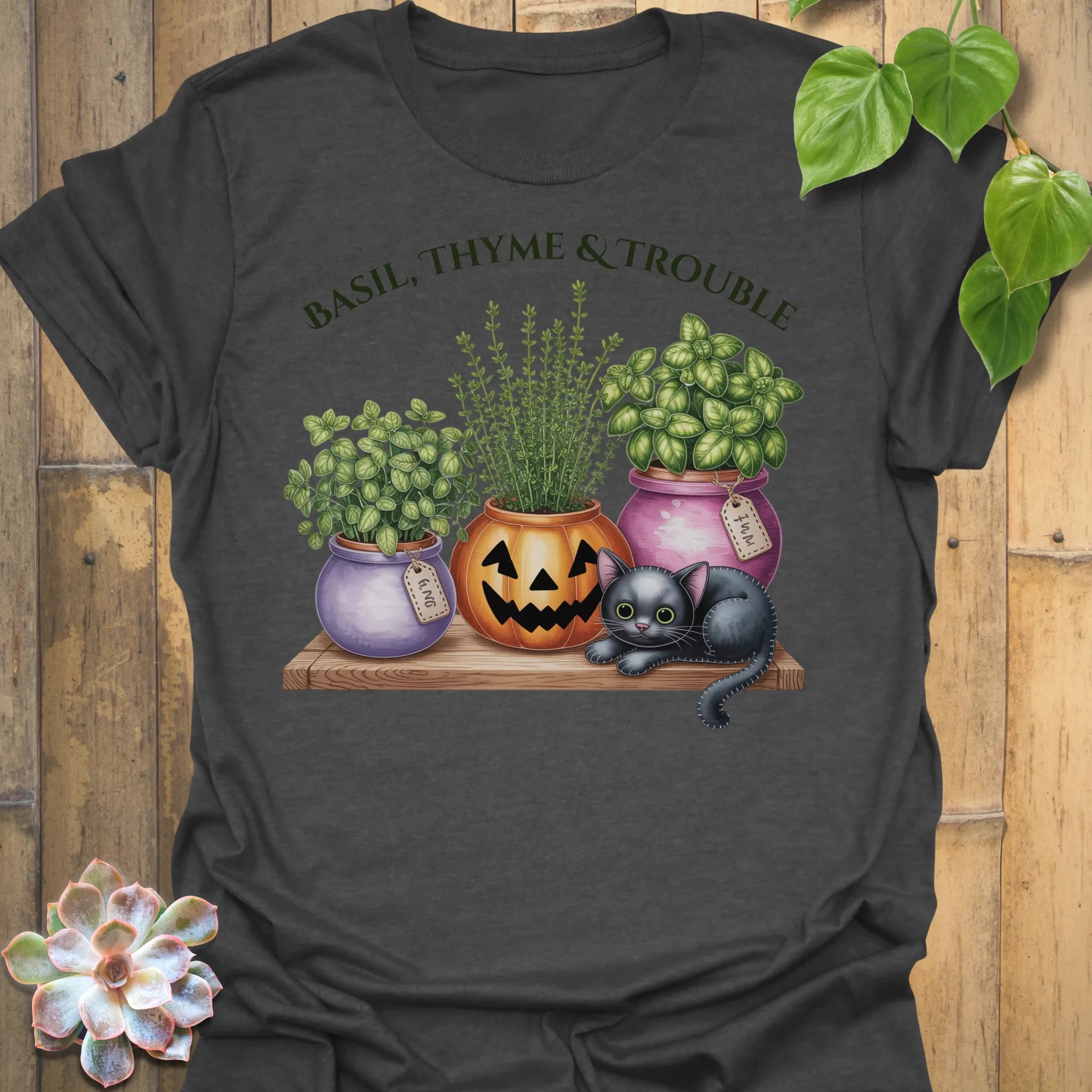 Dark Heather t-shirt featuring the design Basil, Thyme & Trouble printed in bold letters, plant and herb lover tee.