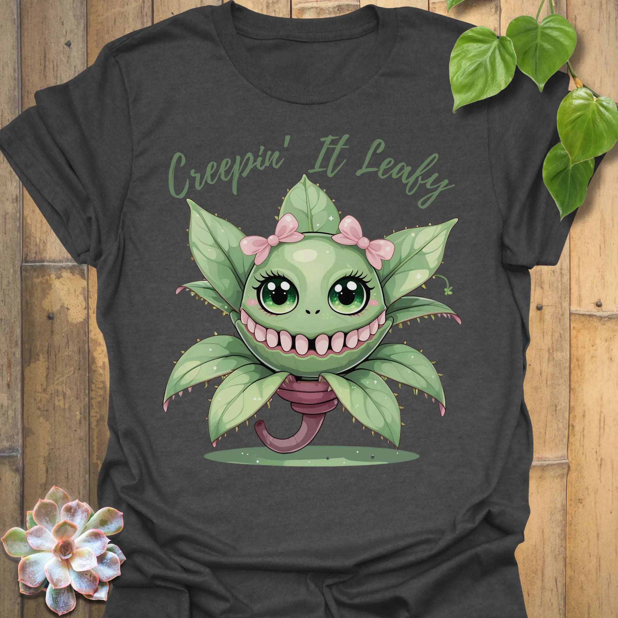 Dark Heather t-shirt featuring the design Creepin’ It Leafy printed in bold black letters, gardening graphic shirt.