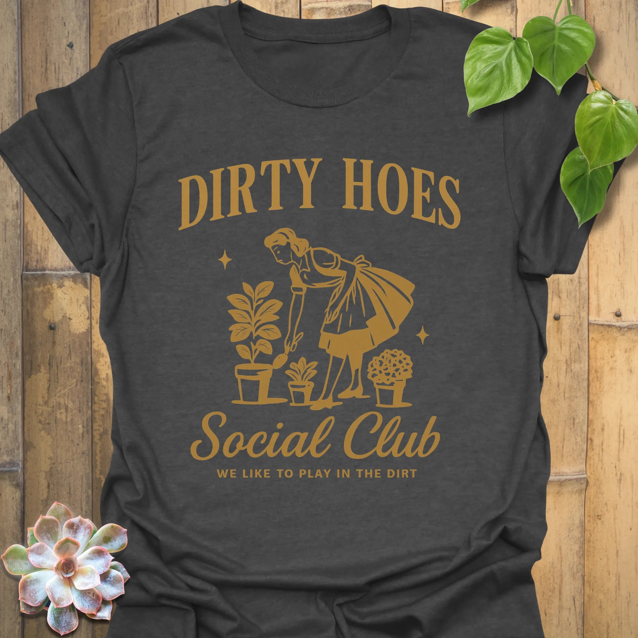Dark Heather t-shirt featuring the design Dirty Hoes printed in bold letters, gardening graphic tee.