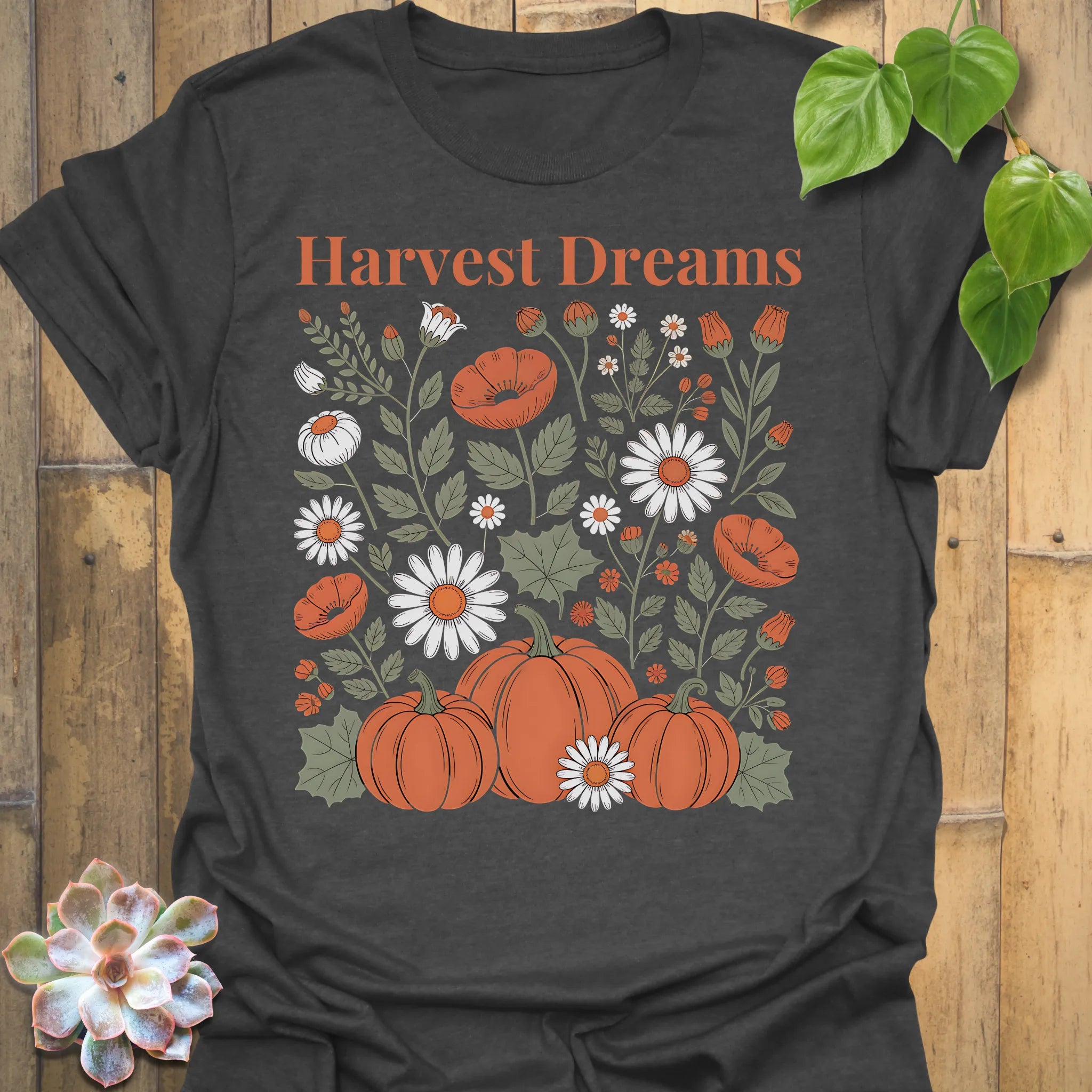 Dark Heather t-shirt featuring the design Harvest Dreams printed in bold orange letters, cosy harvest tee.
