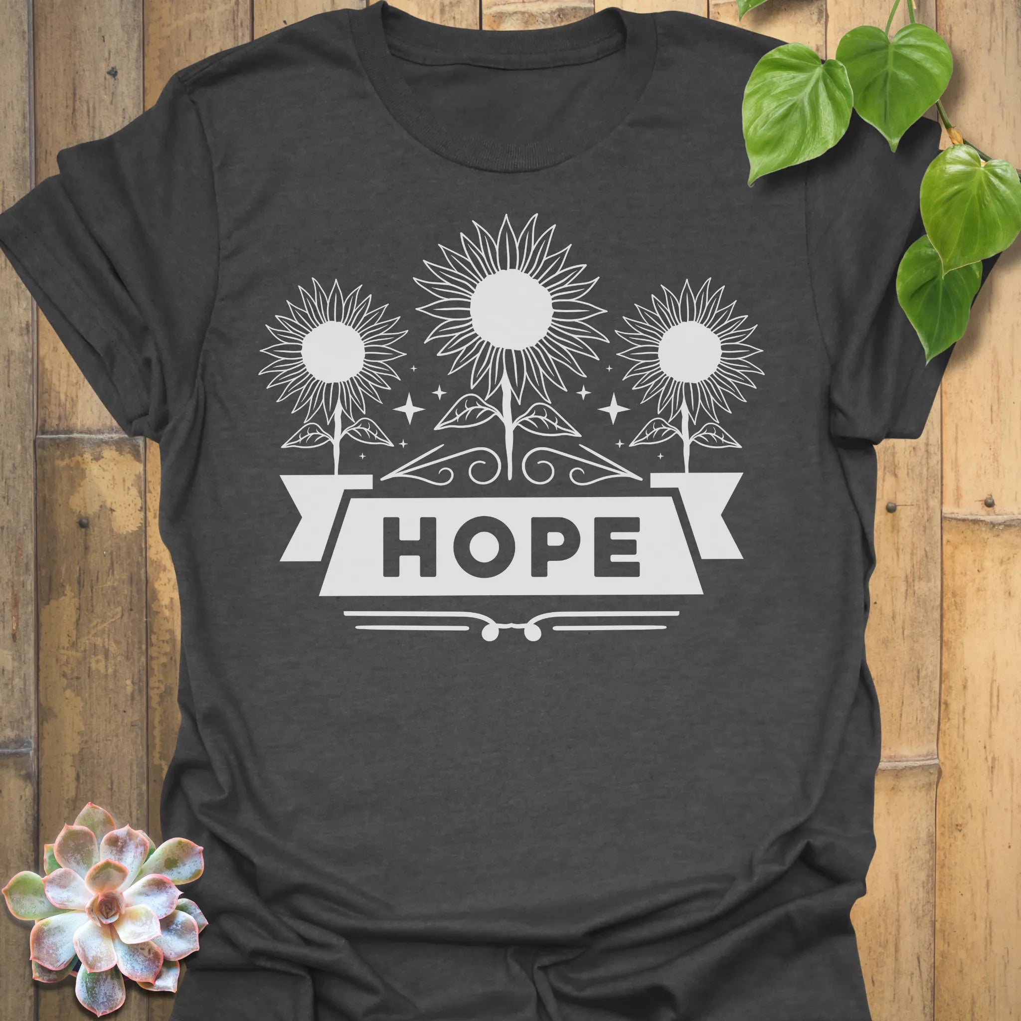 Dark Heather t-shirt featuring the design Hope printed in sunflower and bold letters, positive vibe t-shirt.