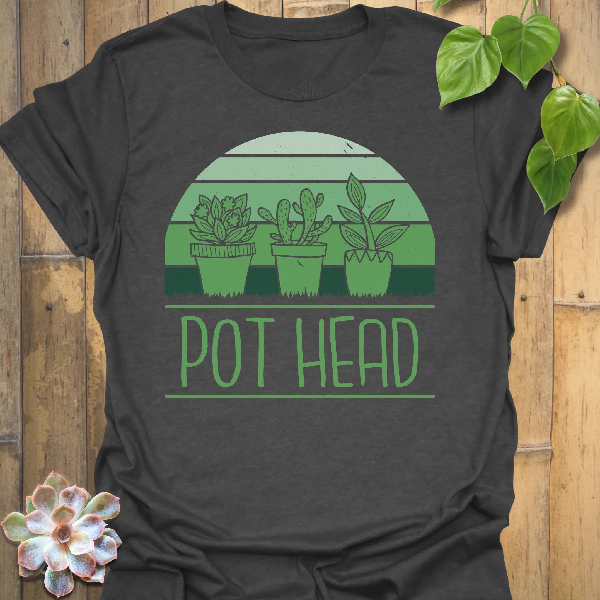 Dark Heather t-shirt featuring the design Pot Head printed in bold green letters, garden lover shirt.