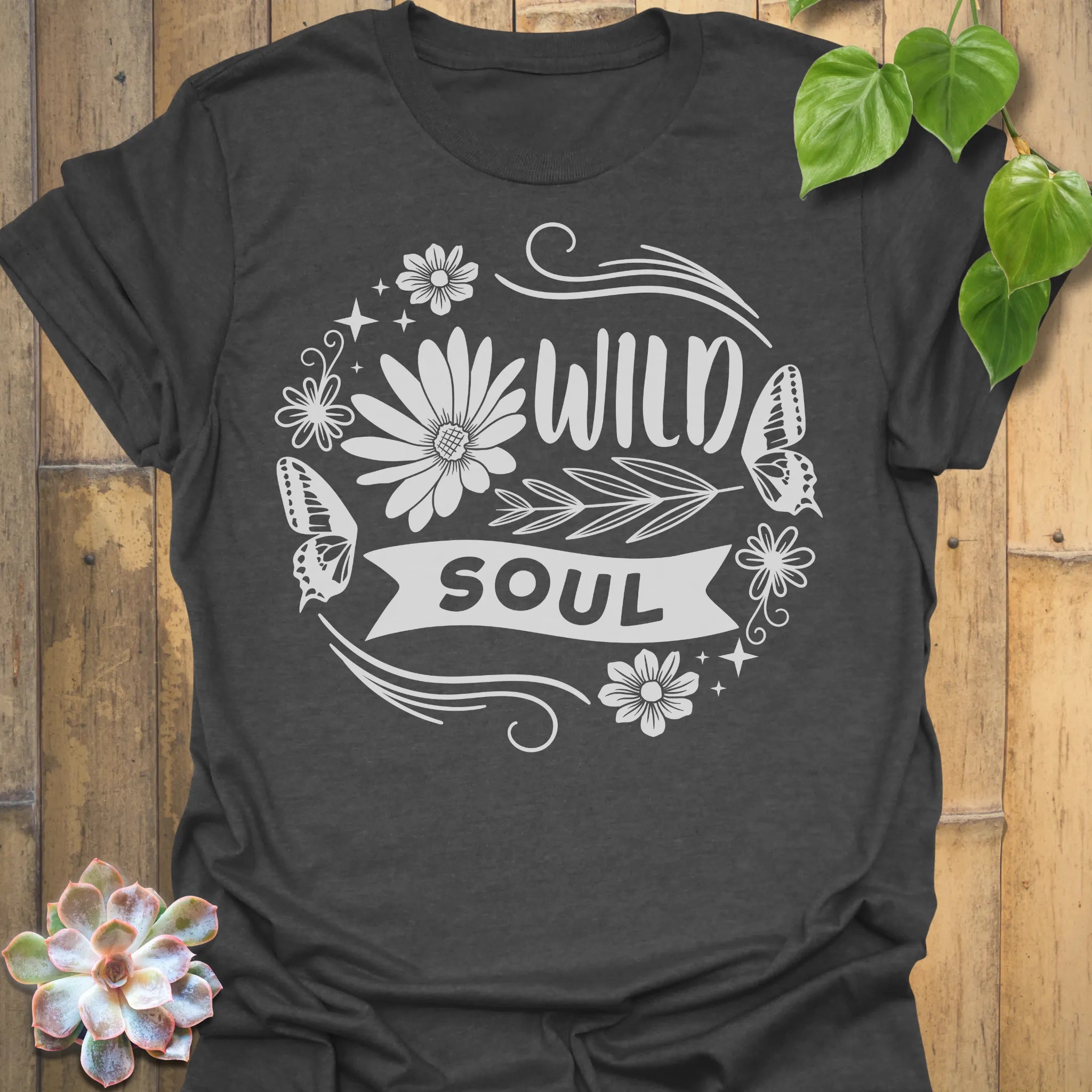 Dark Heather t-shirt featuring the design Wild Soul printed in bold black letters, floral graphic tee.
