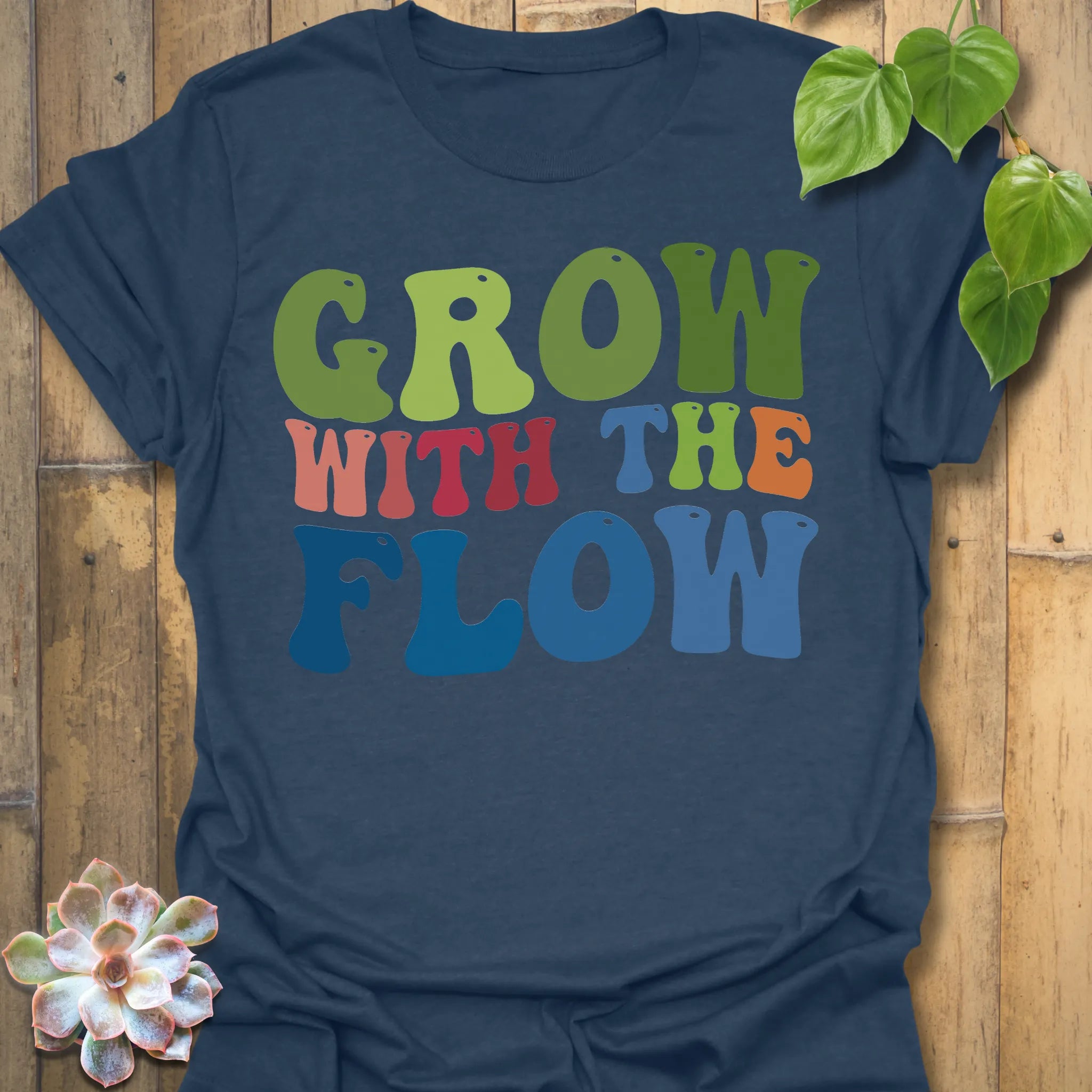 Heather Navy t-shirt featuring the design Grow With The Flow printed in bold colorful letters, mindful garden shirt.