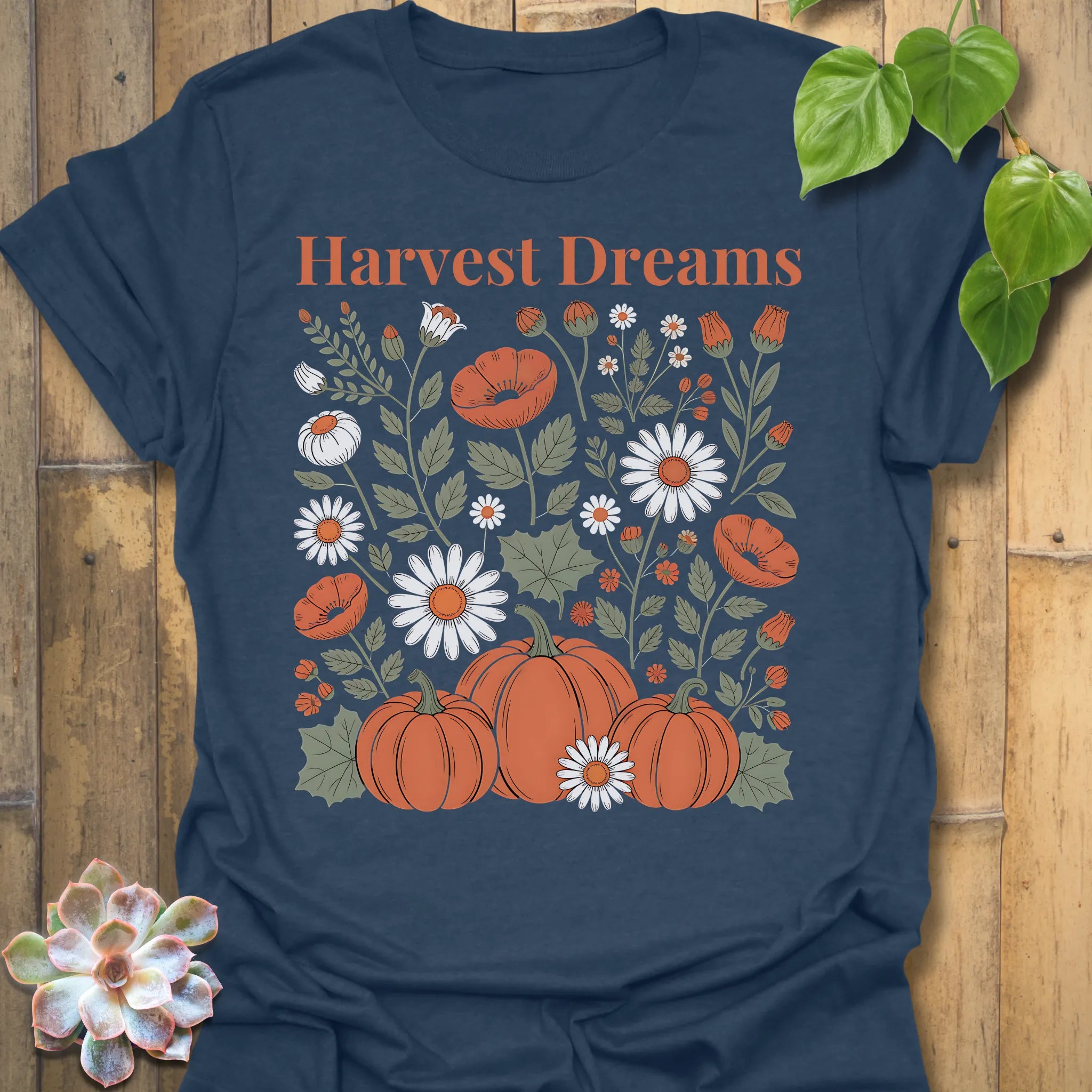 Heather Navy t-shirt featuring the design Harvest Dreams printed in bold orange letters, cosy harvest tee.