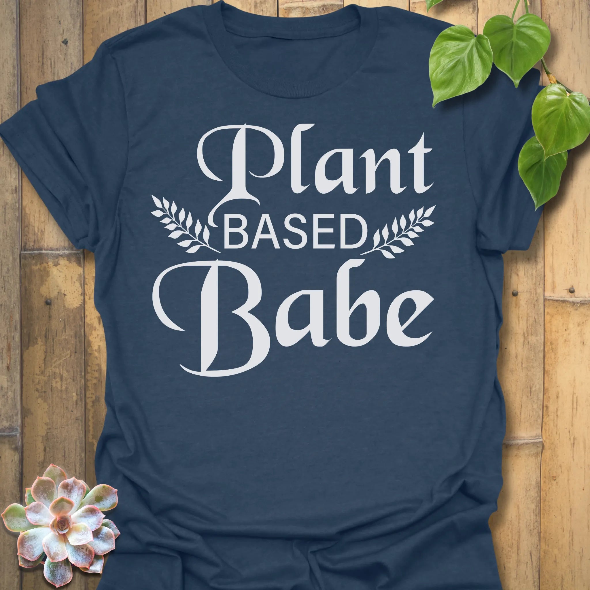 Heather Navy t-shirt featuring the design Plant Based Babe printed in bold white letters, plant lover vegan shirt.