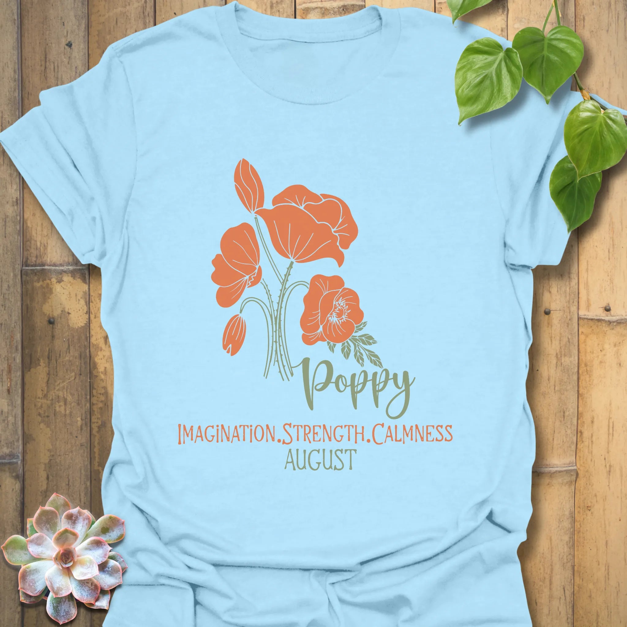 Light Blue t-shirt featuring the design August Poppy with a floral print, a stylish flower graphic tee for relaxed casual looks.