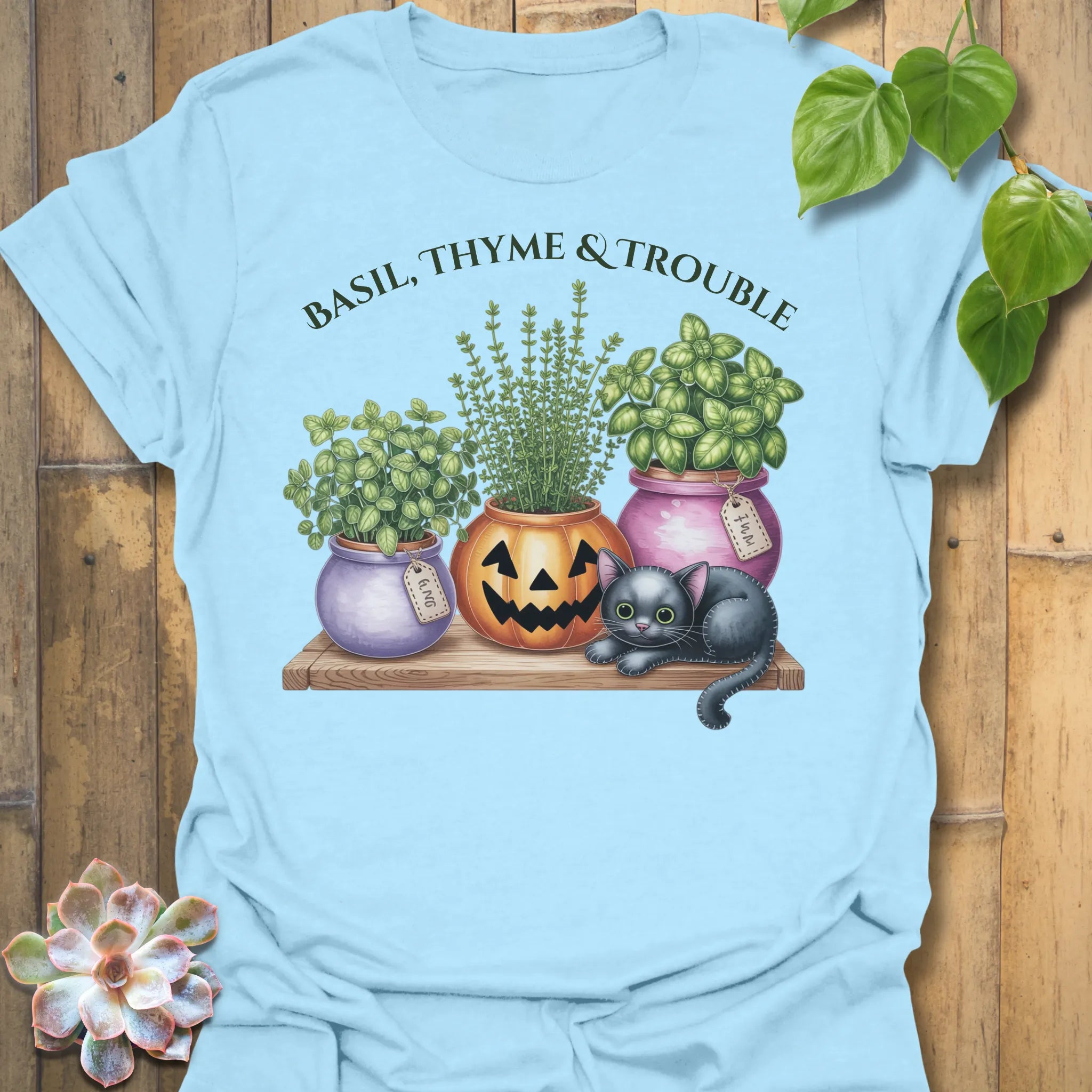 Light Blue t-shirt featuring the design Basil, Thyme & Trouble printed in bold letters, plant and herb lover tee.