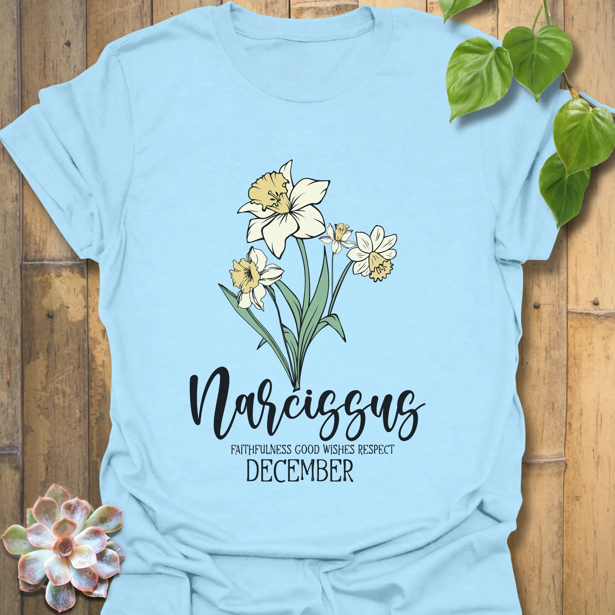 Light Blue t-shirt featuring the design December Narcissus with a detailed narcissus flower illustration, ideal for a nature-inspired botanical tee