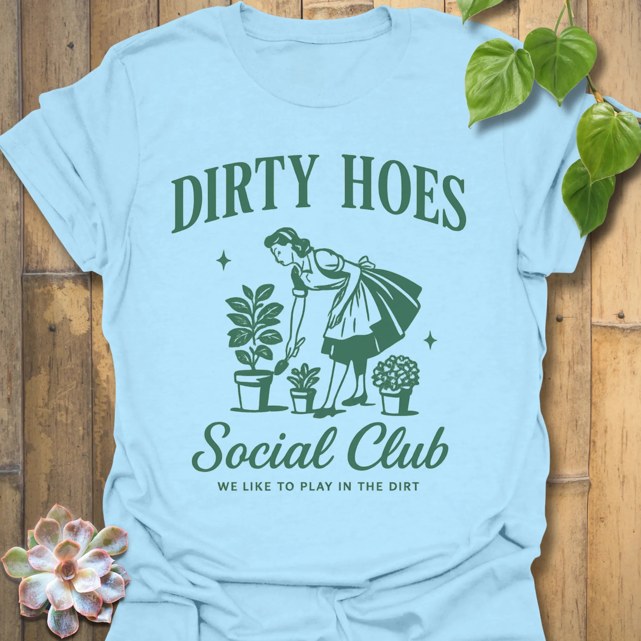 Light Blue t-shirt featuring the design Dirty Hoes printed in bold letters, gardening graphic tee.