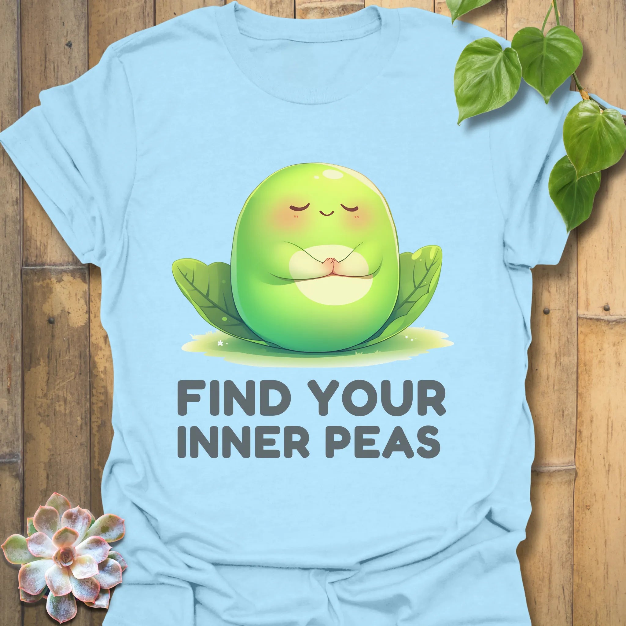Light Blue t-shirt featuring the design Find Your Inner Peas printed in bold green letters with playful pea graphics