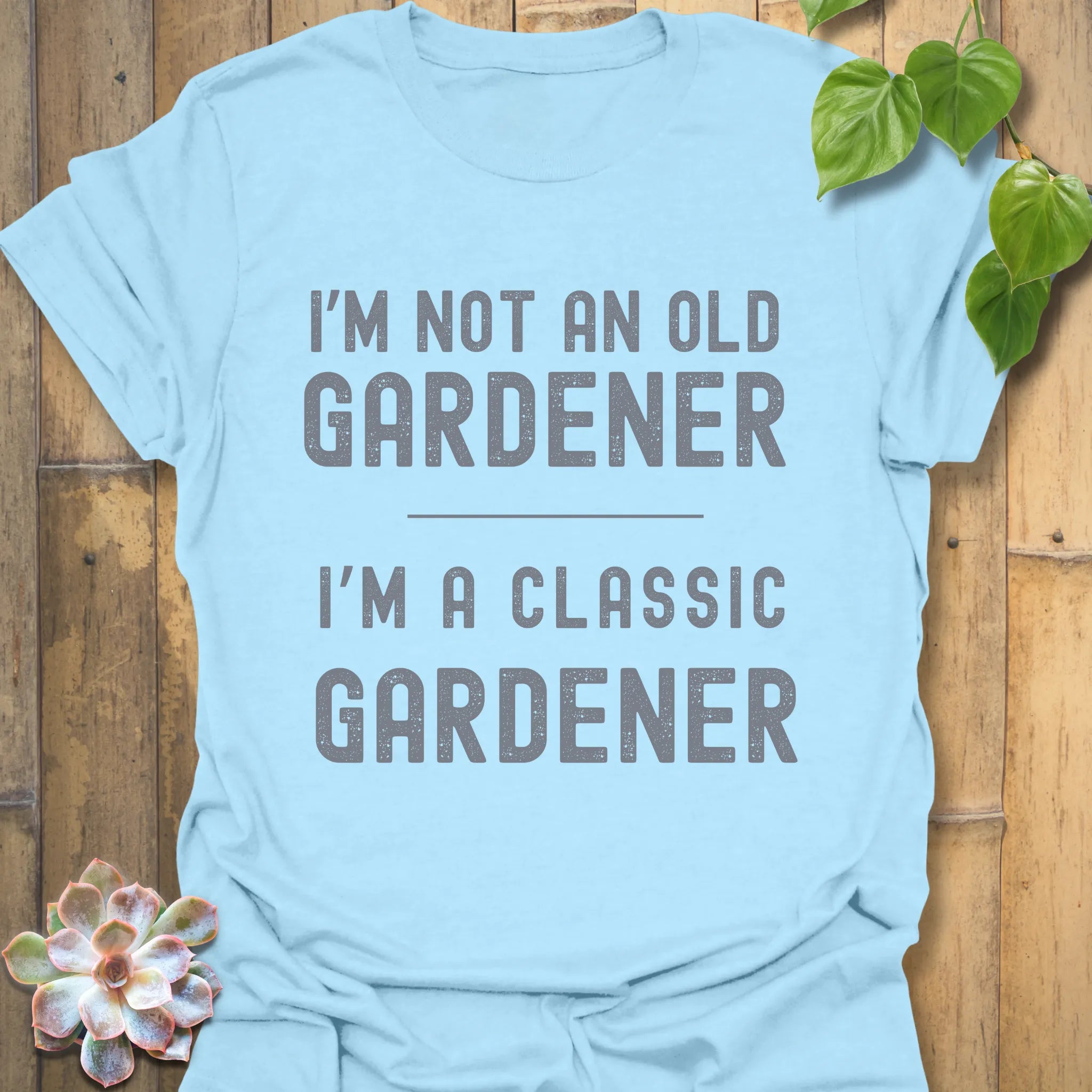 Light Blue t-shirt featuring the design “I’m not an older gardener, I’m a classic gardener” garden lover t-shirt.