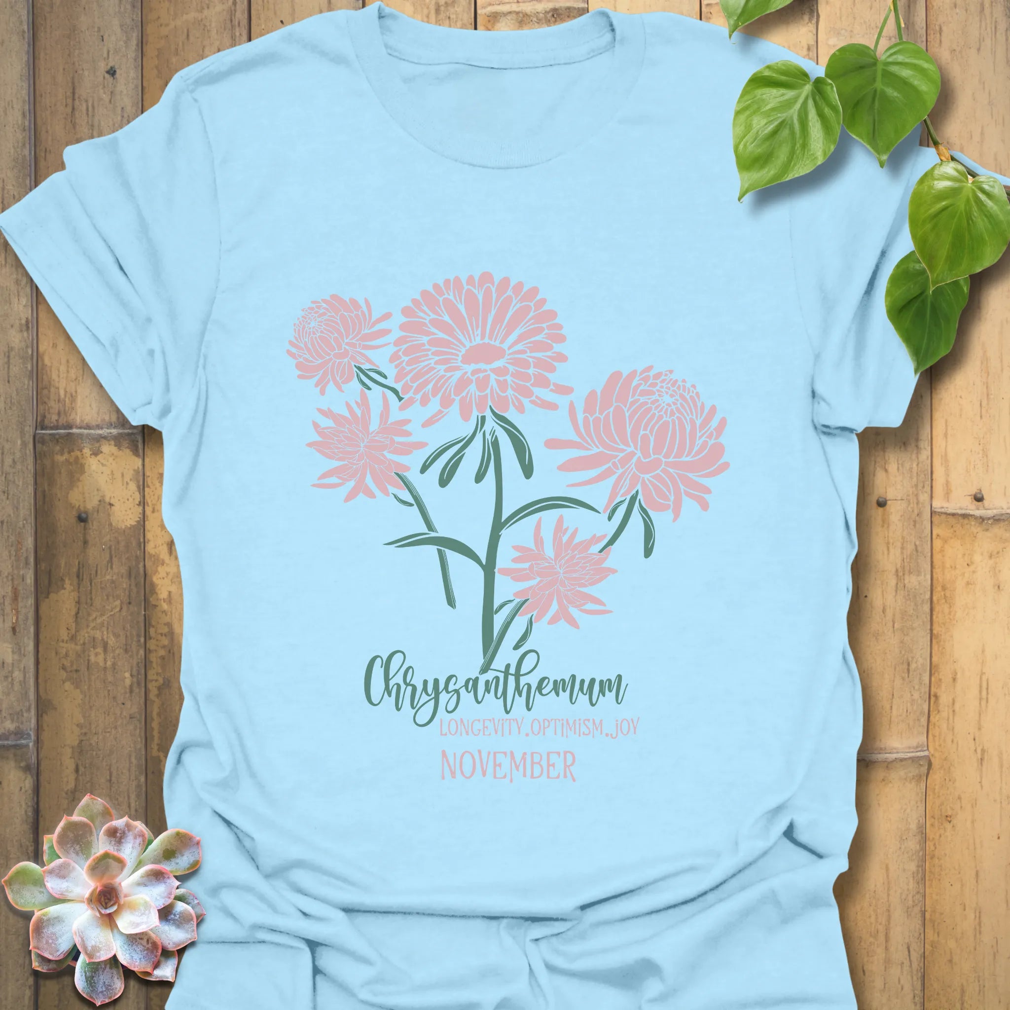 Light Blue t-shirt featuring the design November Chrysanthemum with a chrysanthemum flower print, trendy floral graphic tee for casual outfits.