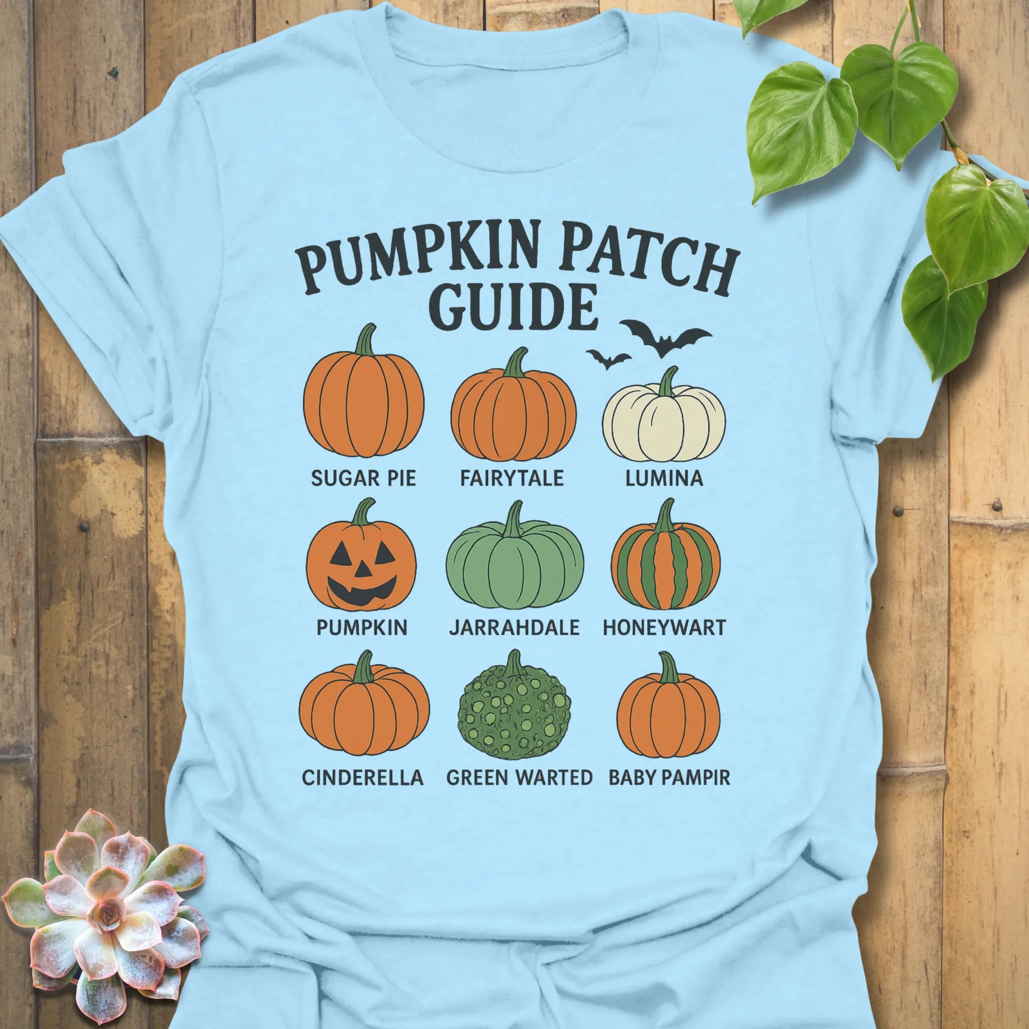 Light Blue t-shirt featuring the design Pumpkin Patch Guide printed in black letters, Halloween pumpkin tee.