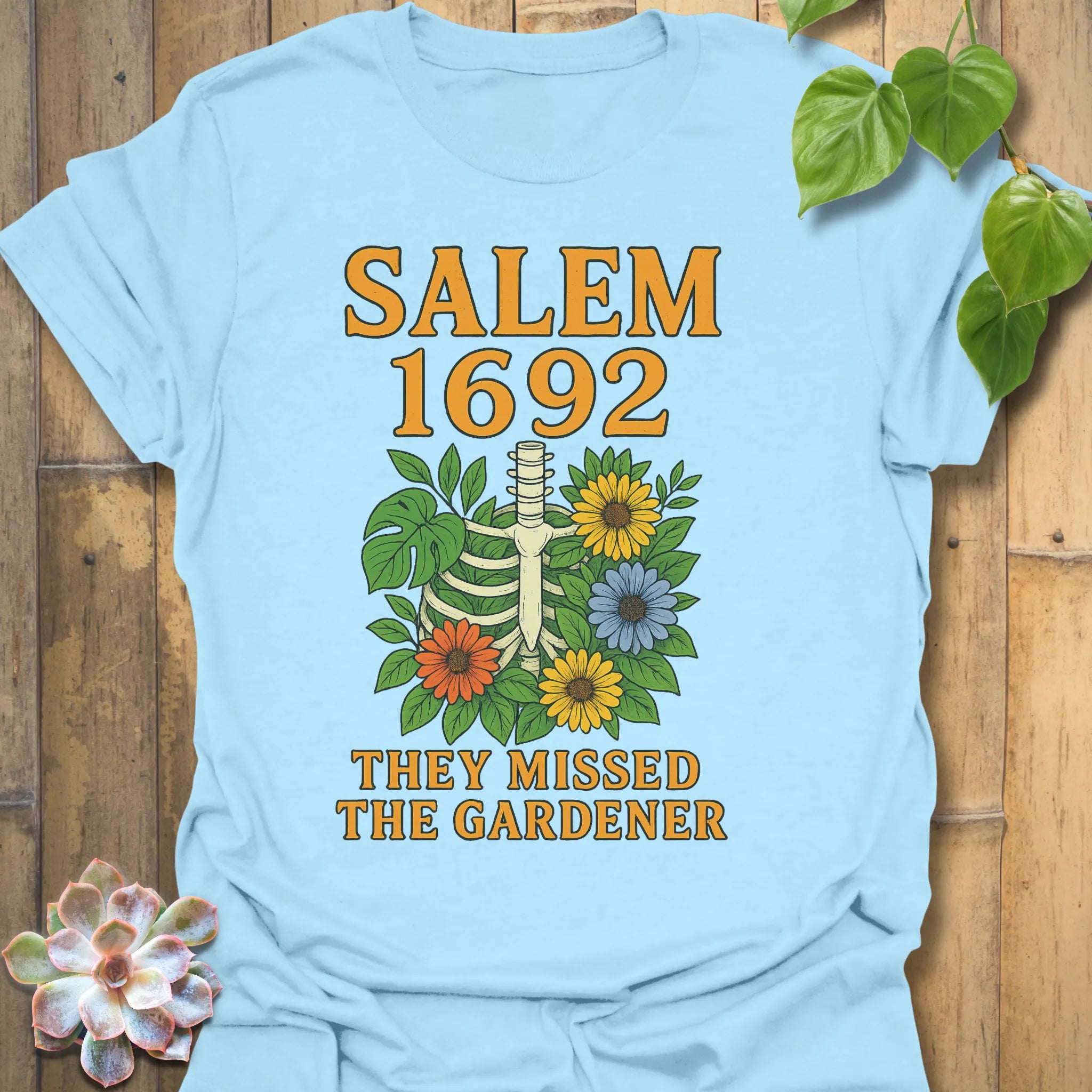 Light Blue t-shirt featuring the design Salem 1692 printed in bold letters, vintage halloween graphic tee.