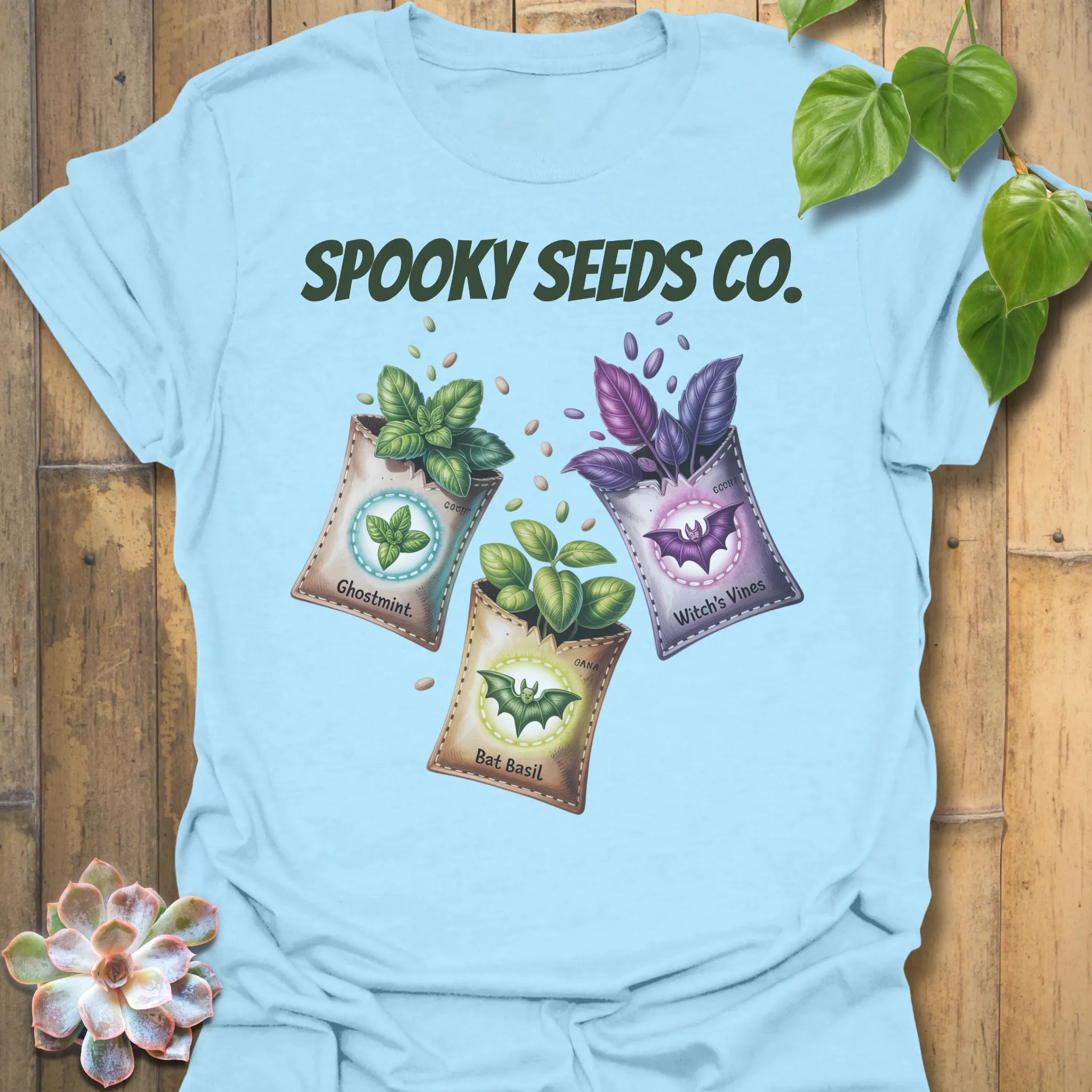 Light Blue t-shirt featuring the design Spooky Seeds Co. printed in bold letters, spooky plant lover shirt.