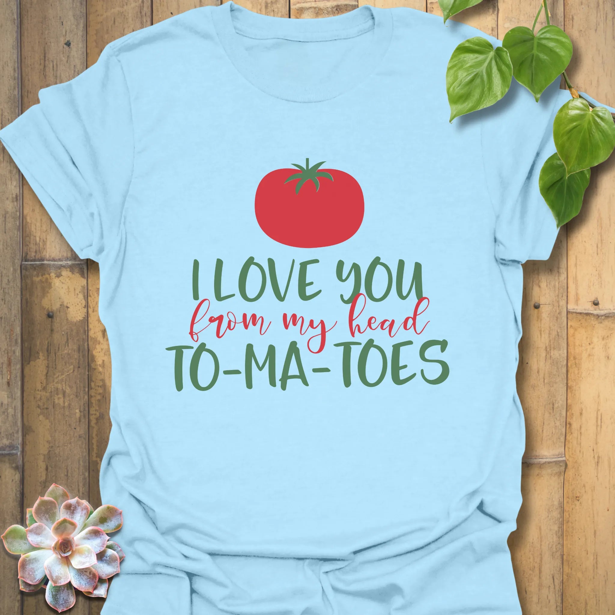 Light blue t-shirt featuring the design I Love You From My Head TO-MA-TOES with playful tomato print, casual humour tee.