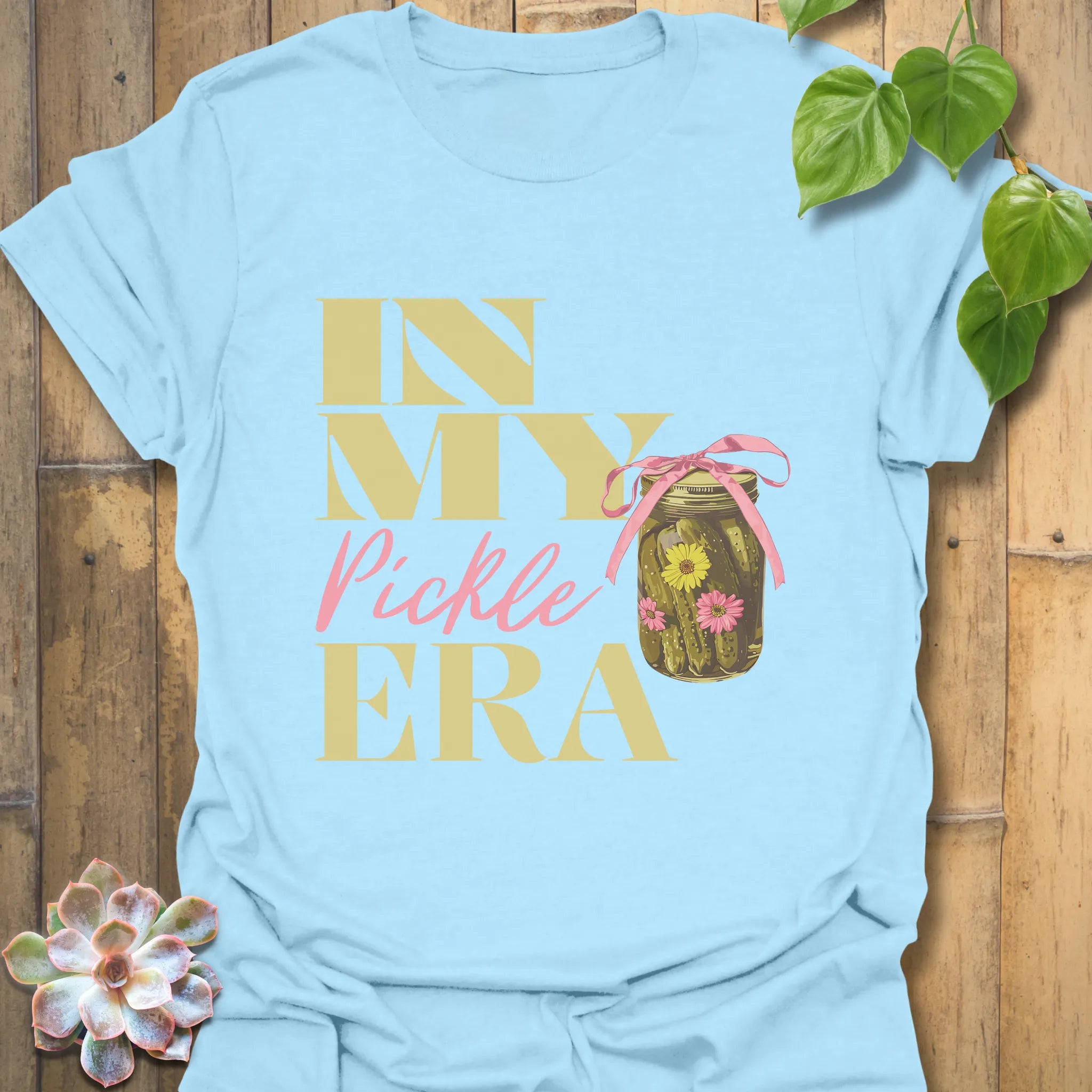 Light blue t-shirt with the text “In My Pickle ERA” and an illustration of cucumbers in a glass jar