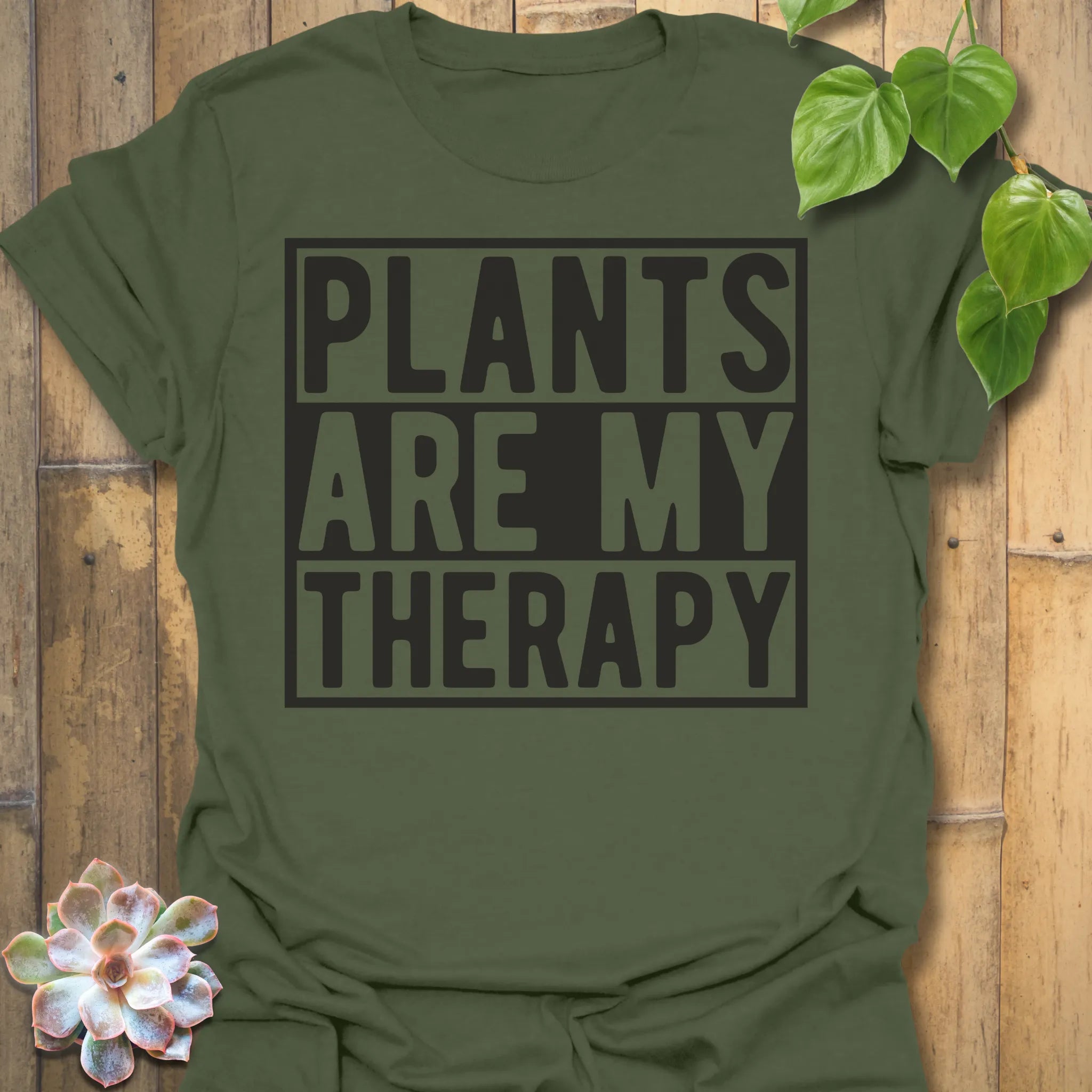Military Green t-shirt featuring the design Plants Are My Therapy printed in bold letters, plant lover shirt.
