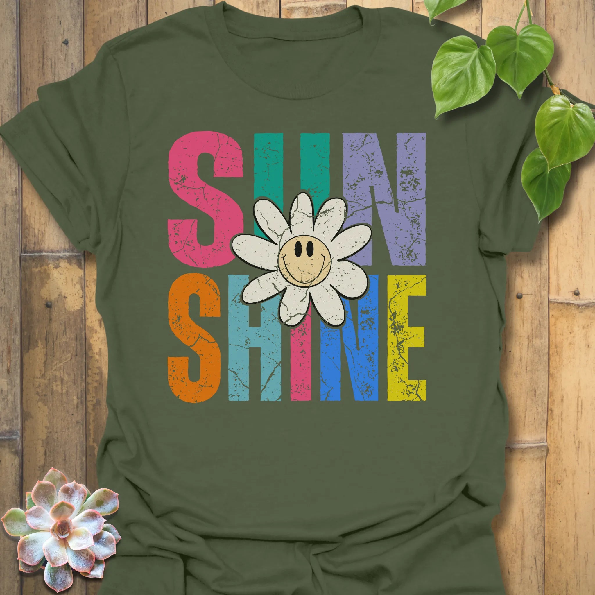 Military Green t-shirt featuring the design Sunshine printed in bold colorful letters, funny sunflower casual summer shirt.
