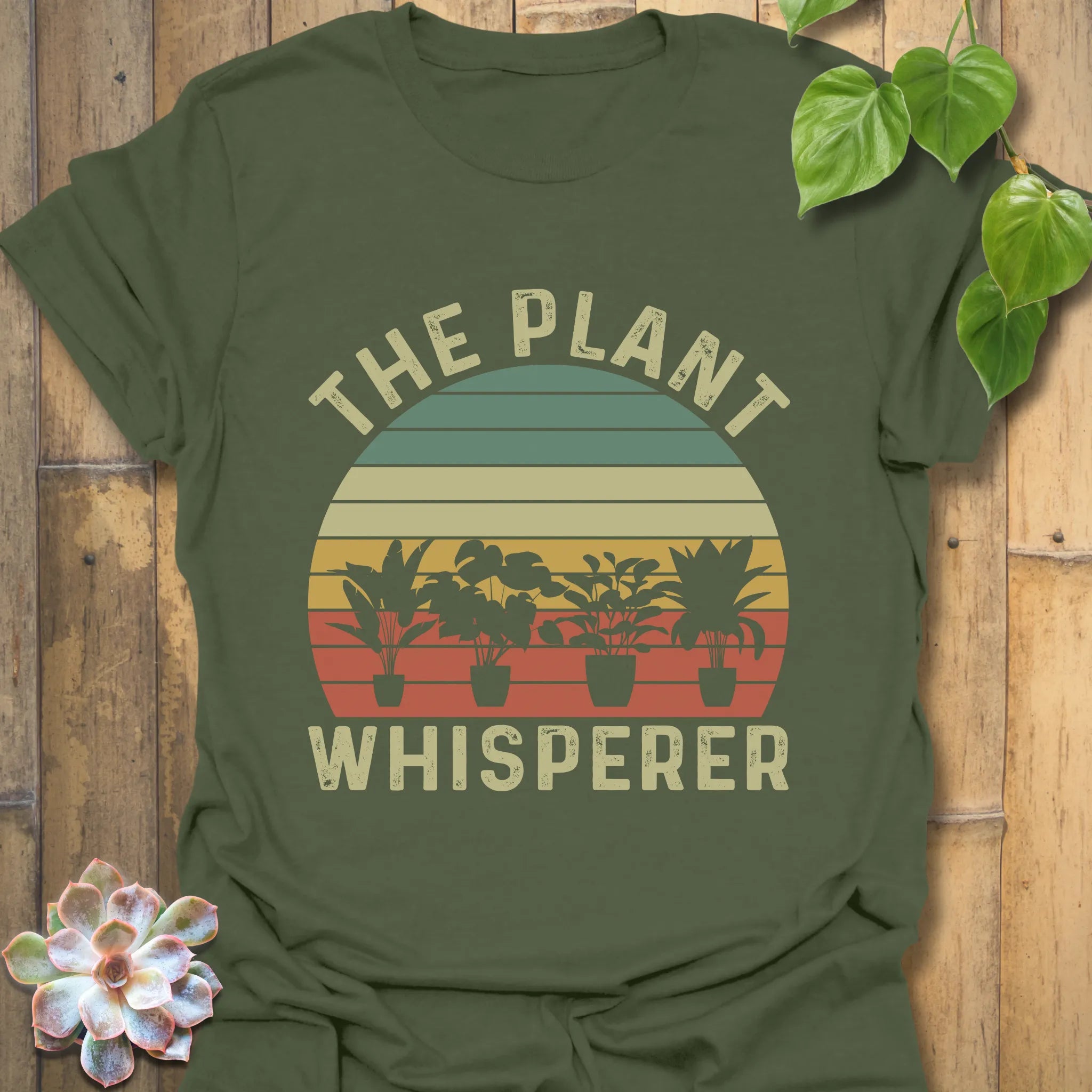 Military Green t-shirt featuring the design The Plant Whisperer with a plant in a pot, a stylish gift for gardening and nature lovers.