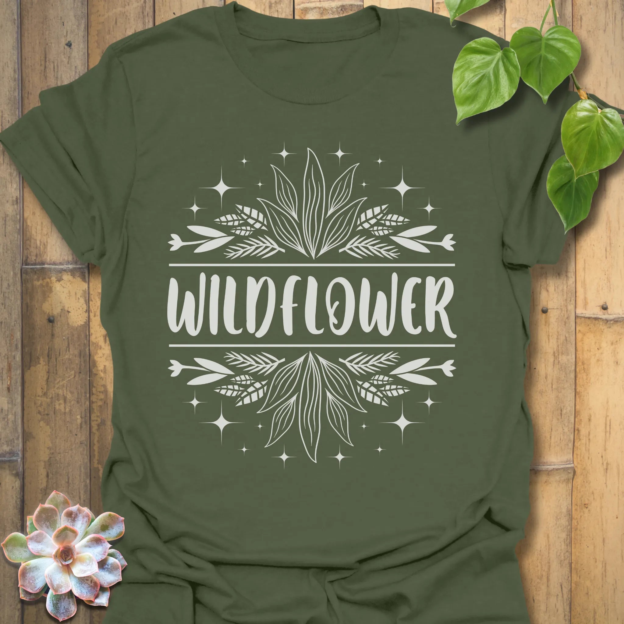 Military Green t-shirt featuring the design Wildflower printed in bold white letters, floral graphic shirt.