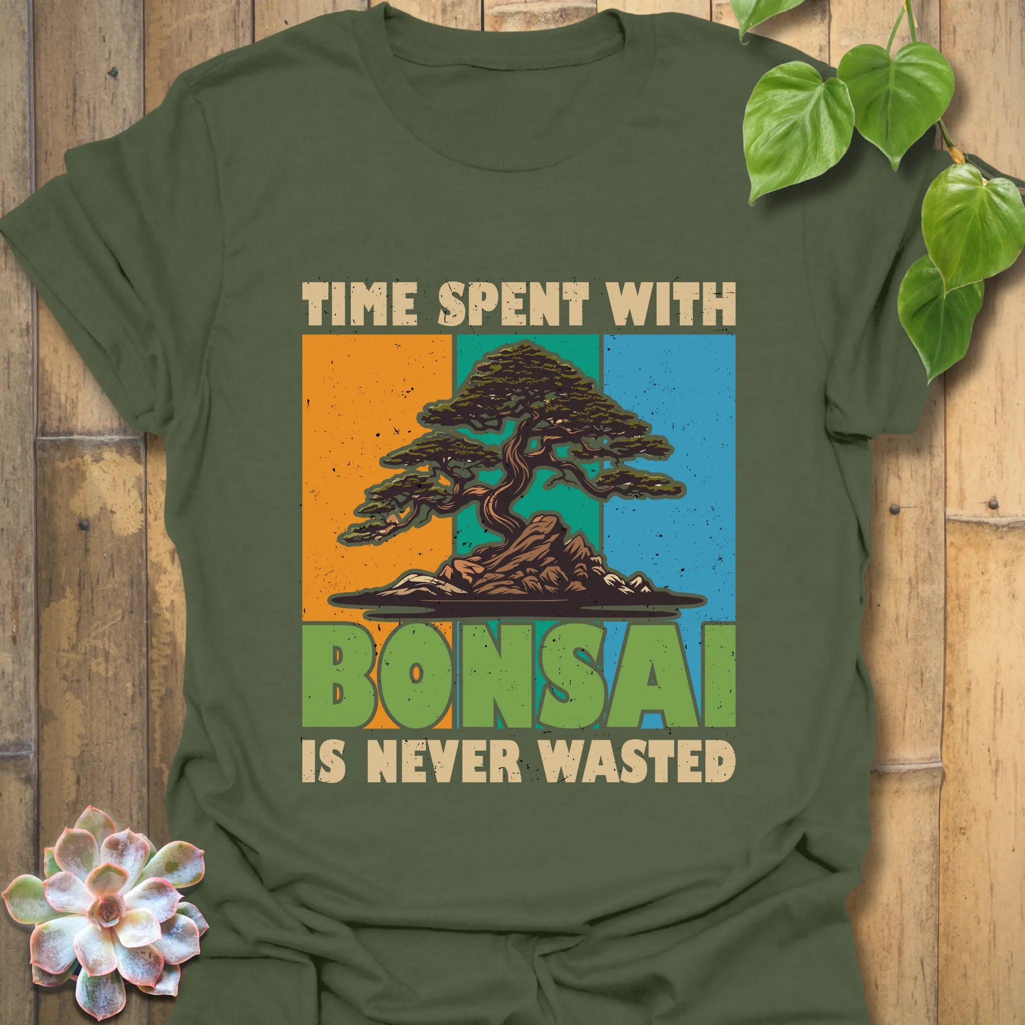 Military green t-shirt featuring the design “Time spent with bonsai is never wasted” with a bonsai plant print, great for outdoor wear and bonsai lovers.