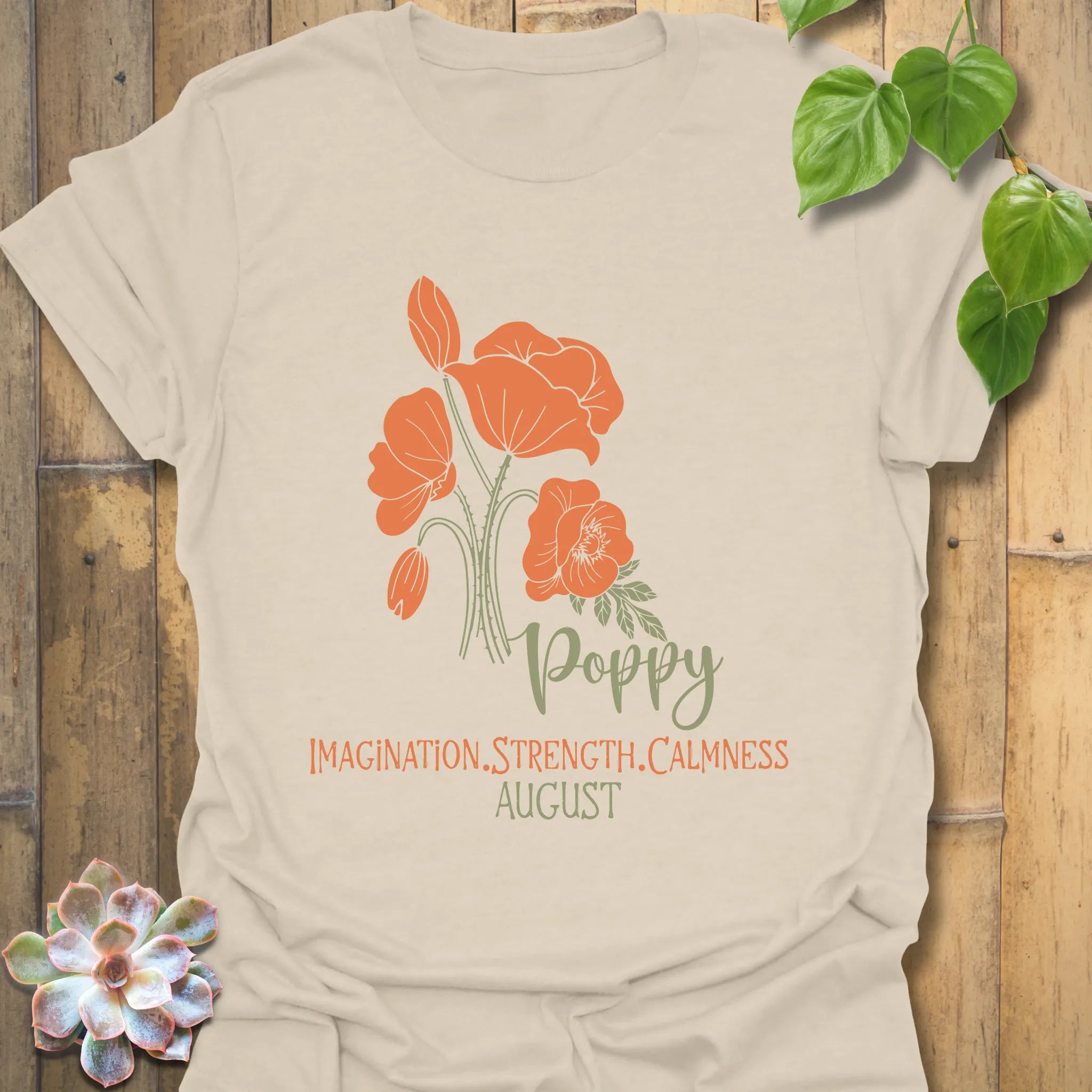 Natural t-shirt featuring the design August Poppy with a delicate flower print, a soft neutral tee ideal for everyday outfits.
