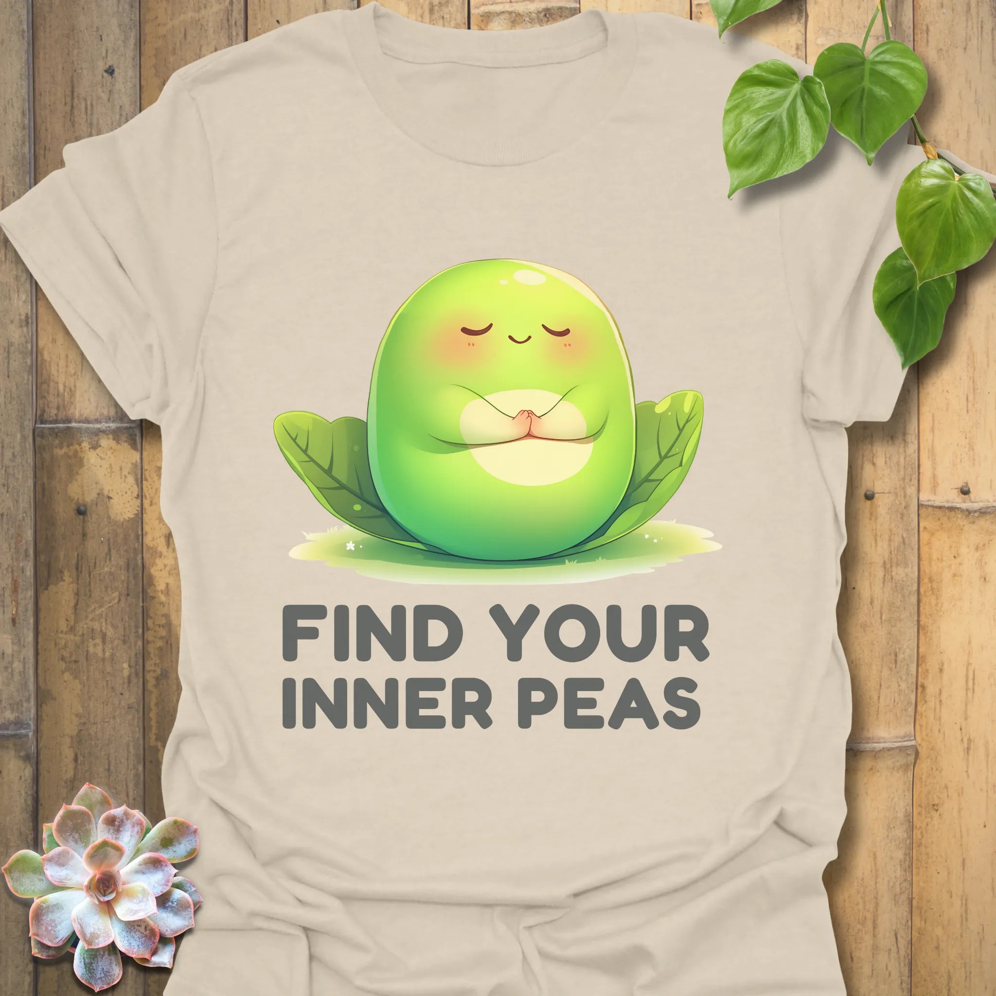 Natural t-shirt featuring the design Find Your Inner Peas printed in bold green letters with playful pea graphics
