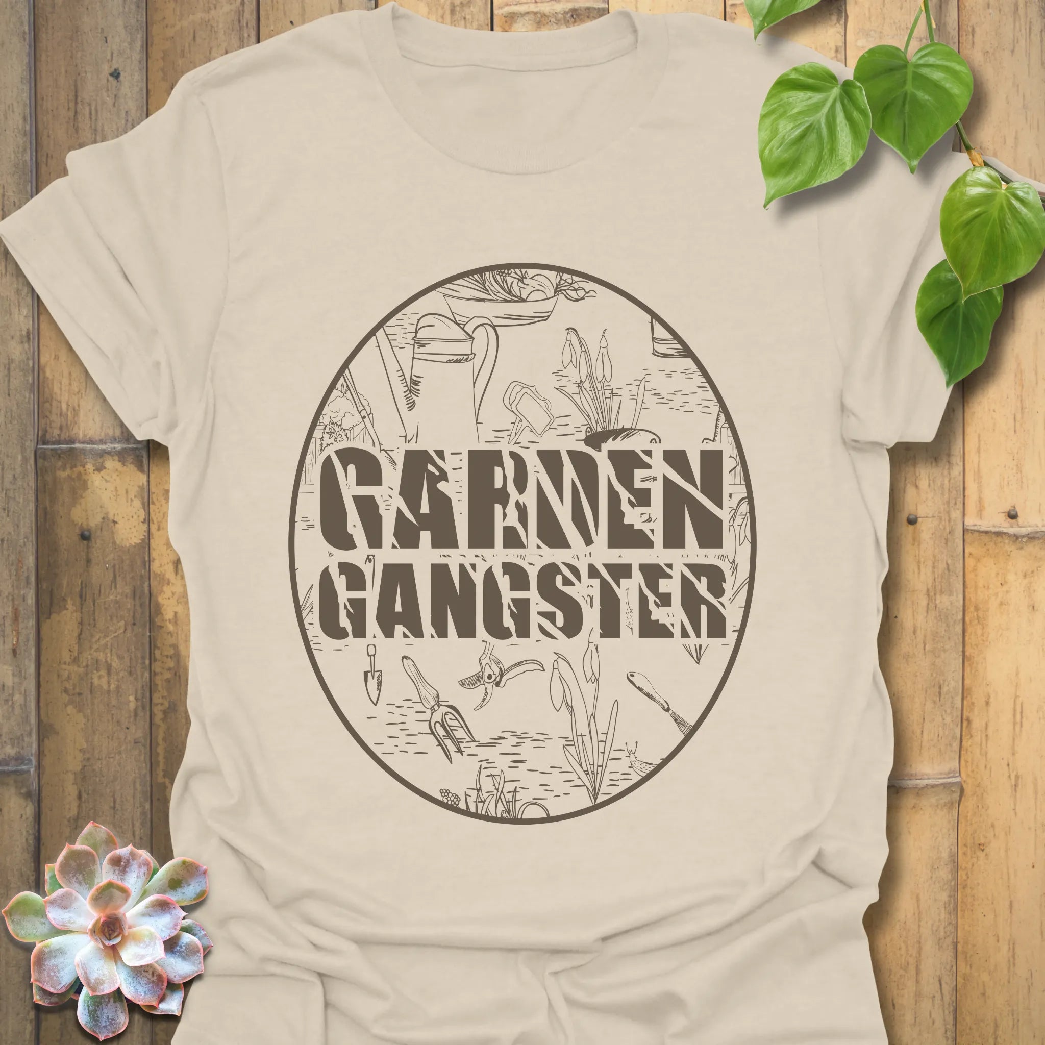 Natural t-shirt featuring the design Garden Gangster with printed garden tools, eco-friendly gardening shirt for casual wear.