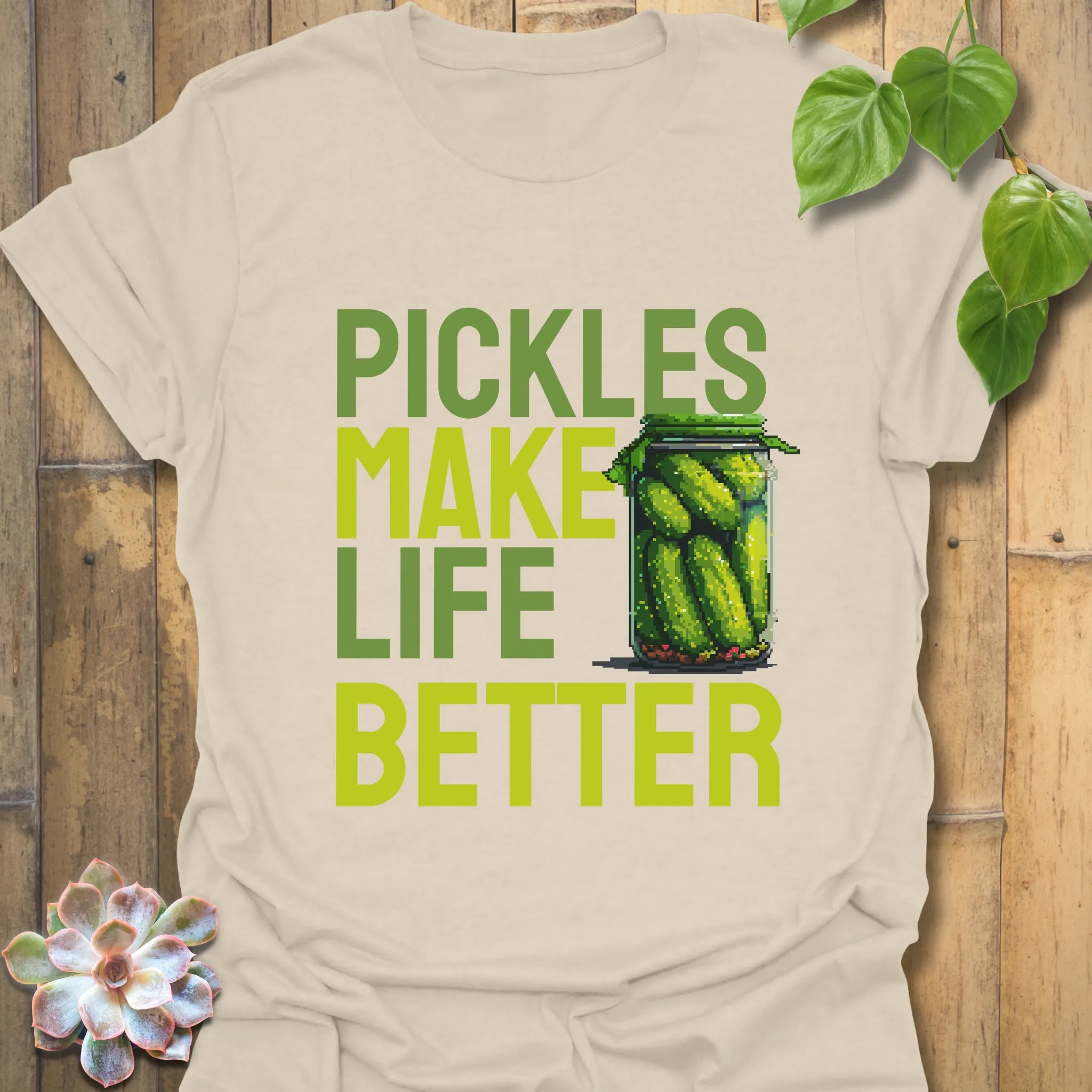 Natural t-shirt featuring the design “Pickles make life better” with cucumbers inside a glass jar